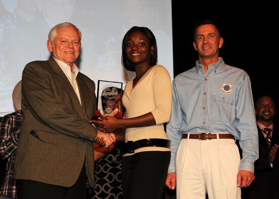 SCOTT AIR FORCE BASE, Ill. – General Authur Lichte, Air Mobility Command commander and Chief Master Sgt. Joseph Barron, AMC command chief, present McConnell Airman 1st Class Ruth Rogers, 22nd Logistic Readiness Squadron, with a plaque and coin for her performance as a finalist in the AMC Icon command performance, Oct. 23.  (photo by Senior Airman Jonathan Lovelady, 375th Airlift Wing Public Affairs)