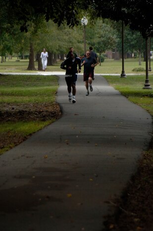 Members of the 437th Airlift Wing staff run to the finish line during a Wingman Day activity on base Oct. 27. Squadrons and units on base participated in various Wingman Day events to bring members together and provide information to create a culture of responsible choices. (U.S. Air Force photo/Airman 1st Class Timothy Taylor)