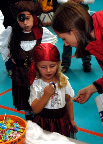 Sydney Myers gets a prize from the candy bowl during the fall festival on base Oct. 24. The base Youth Programs sponsored the fall festival with games, prizes and a costume contest for military families. Sydney is the daughter of Lindsey and Petty Officer 1st Class Paul Myers from the Naval Weapons station Charleston. (U.S. Air Force photo/Airman 1st Class Timothy Taylor)