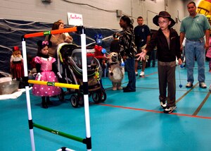 Tyler Power plays a game during the fall festival on base Oct. 24. The base Youth Programs sponsored the fall festival with games, prizes and a costume contest for military families. Tyler is the son of Staff Sgt. Steven Power who is with the 315th Aircraft Maintenance Squadron. (U.S. Air Force photo/Airman 1st Class Timothy Taylor)

