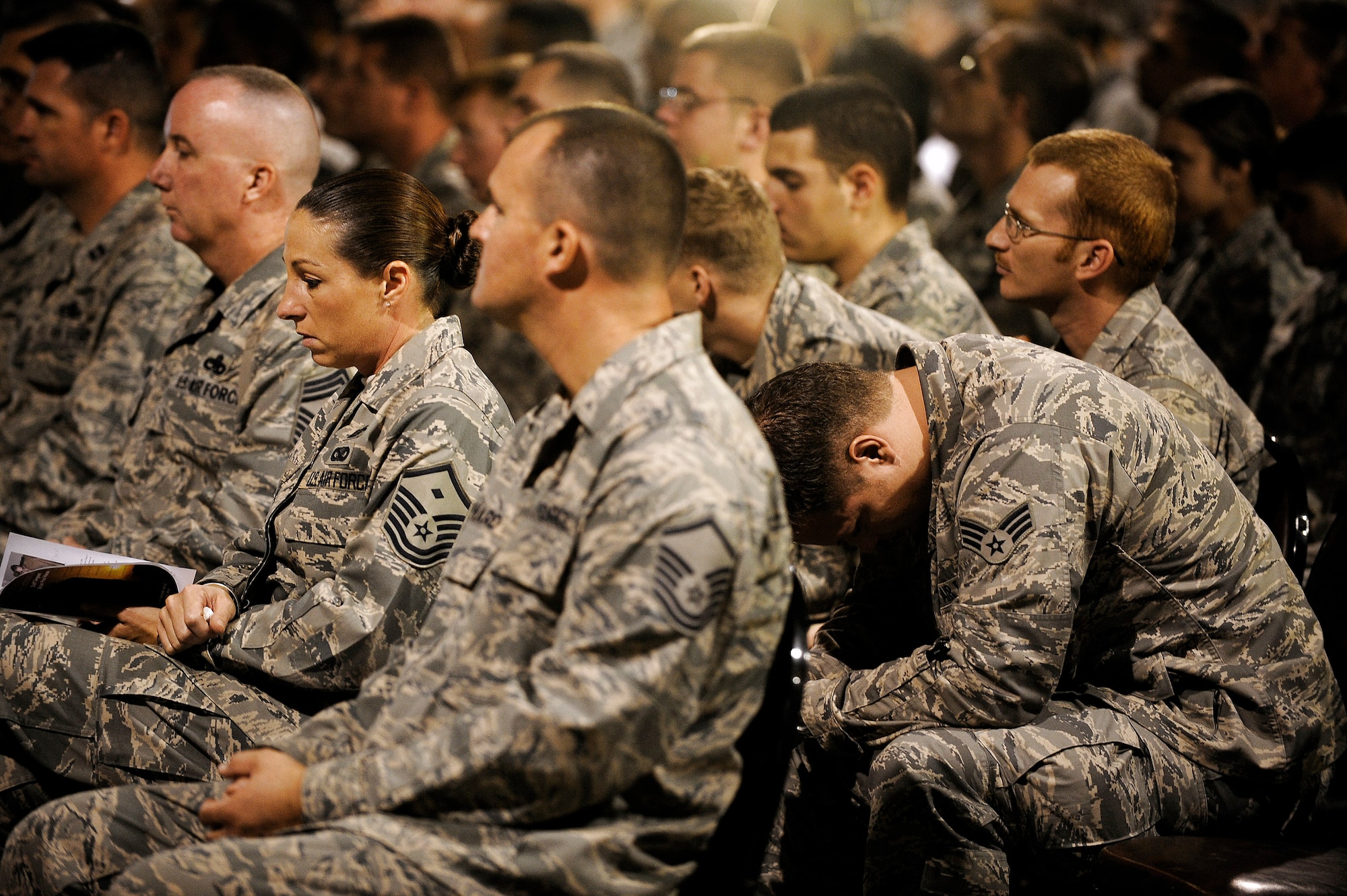 Senior Airman Jason Watkins (right) mourns the death of Staff Sgt. Brian Hause during a memorial service held in his honor Oct. 27 at Joint Base Balad, Iraq. Sergeant Hause received an Air Force Commendation Medal and Iraq Campaign Medal posthumously for his contributions while deployed to the 332nd Expeditionary Maintenance Squadron here from Shaw Air Force Base, S.C. Airman Watkins, who deployed with Sergeant Hause, was a co-worker and friend and spoke at the memorial about memories he'll cherish. (U.S. Air Force photo/Airman 1st Class Jason Epley) 