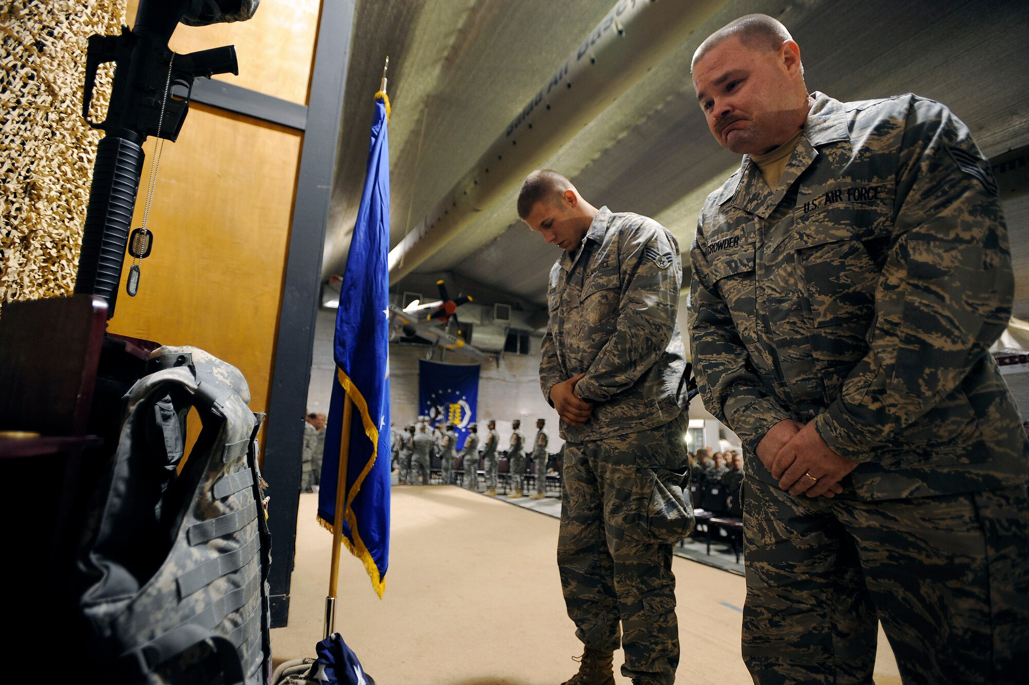 Tech. Sgt. Charles Crowder (right) mourns the death of Staff Sgt. Brian Hause during a memorial service held in his honor Oct. 27 at Joint Base Balad, Iraq. Sergeant Hause received an Air Force Commendation Medal and Iraq Campaign Medal posthumously for his contributions while deployed here from Shaw Air Force Base, S.C. Sergeant Crowder, a weapons expediter with the 332nd Expeditionary Maintenance Squadron, is also deployed from Shaw AFB. (U.S. Air Force photo/Airman 1st Class Jason Epley) 
