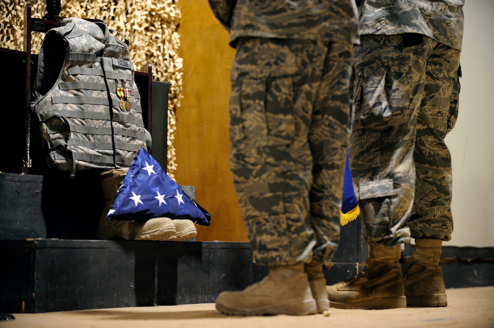 Two Airmen pay their respects to Staff Sgt. Brian Hause during a memorial service held in his honor Oct. 27 at Joint Base Balad, Iraq. Sergeant Hause received an Air Force Commendation Medal and Iraq Campaign Medal posthumously for his contributions while deployed here from Shaw Air Force Base, S.C. (U.S. Air Force photo/Airman 1st Class Jason Epley) 
