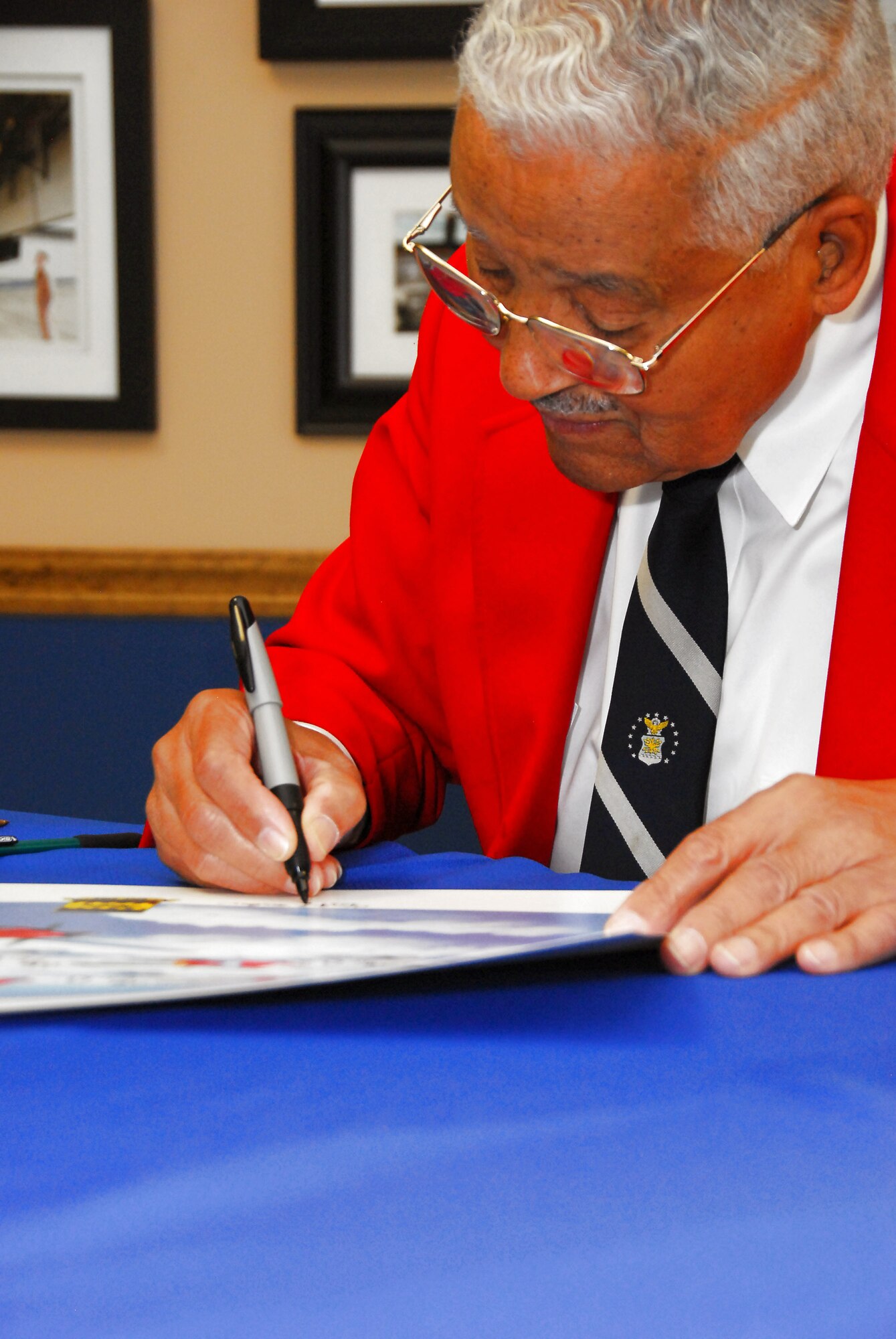 Retired Col. Charles McGee, one of the original Tuskegee Airmen, signs autographs after speaking to Squadron Officer School students at the Warrior Symposium at Maxwell Air Force Base, Ala., Oct. 16. (U.S. Air Force photo/Scott Knuteson) 
