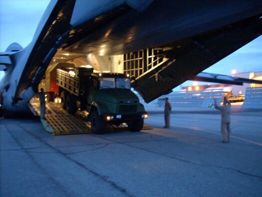 The 512th Airlift Control Flight assists a New York Air National Guard crew with the second of three C-5 downloads, designated to deliver a Russian radar system to Eielson Air Force Base, Ala., in support of Red Flag Alaska Sept. 11-21. (U.S. Air Force photo)           