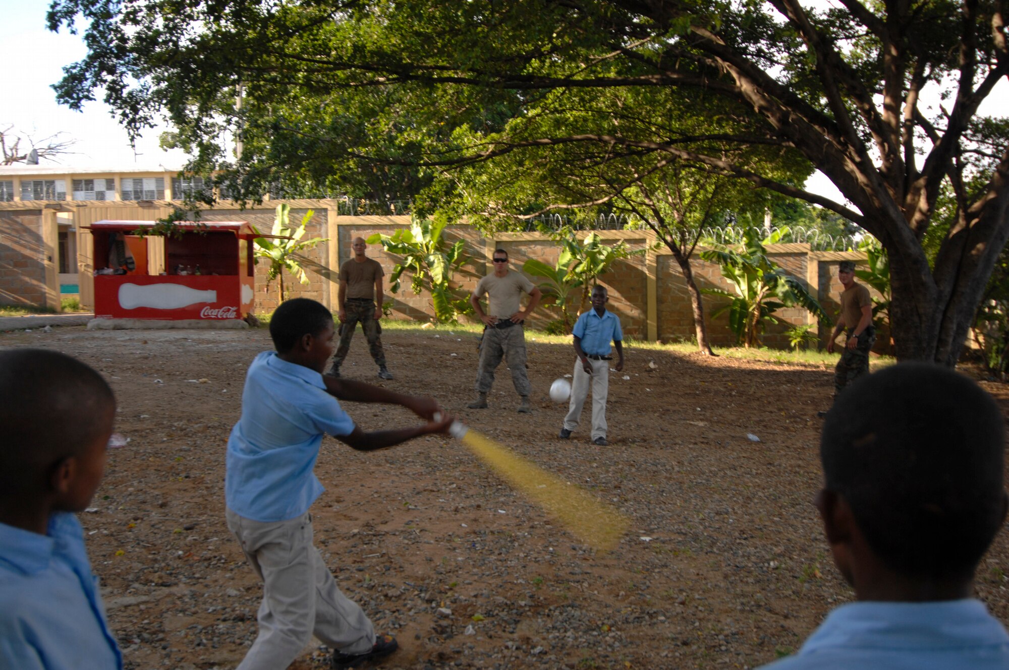 SANTO DOMINGO, Dominican Republic -- Airmen from the 5th Civil Engineer Squadron Prime Base Engineer Emergency Force and Navy Seabees,currently embarked aboard USS Kearsarge (LHD 3), take a break and join Dominican children in a game of baseball at Soccoro Sanchez Primary School. Airmen from the 5th CES and Navy engineers are working together to repair and improve the school in support of the humanitarian/civic assistance mission Continuing Promise (CP) 2008. CP 2008 is a collaborative effort between the United States and partner militaries, non-governmental organizations, and partner-nation support organizations to build strong partnerships that can be called upon in the event of a regional situation requiring cooperative solutions. (U.S. Navy photo by Mass Communication Specialist Seaman Ernest Scott)