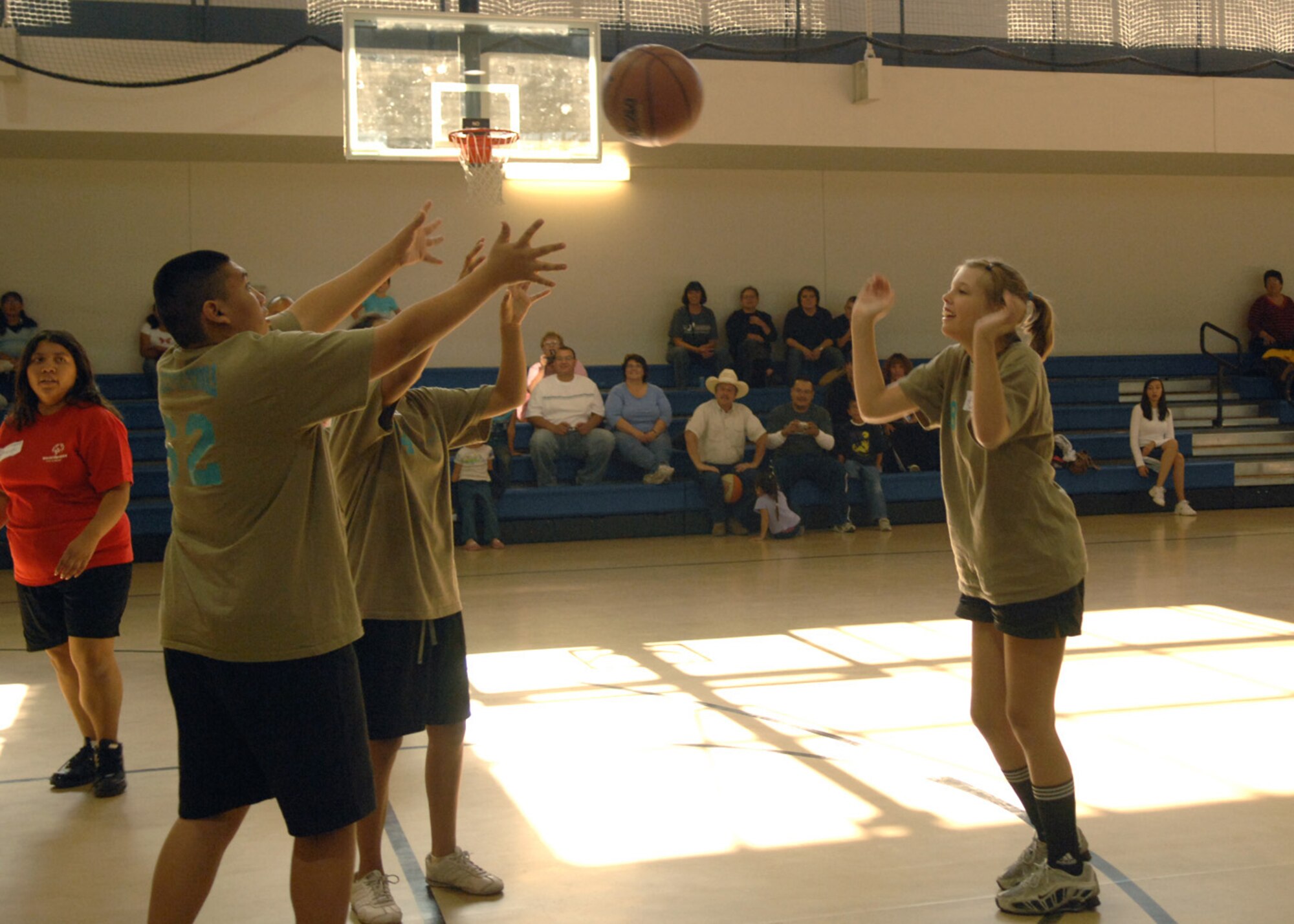 Sacia, basketball player from Zia Middle School, passes the ball over to her team-mates for a winnging shot during the Special Olympics basketball game October 24. Members from Holloman and the Las Cruces community came out to Holloman Air Force Base, N.M., to support the athletes. (U.S. Air Force photo/Airman 1st Class Veronica Salgado)