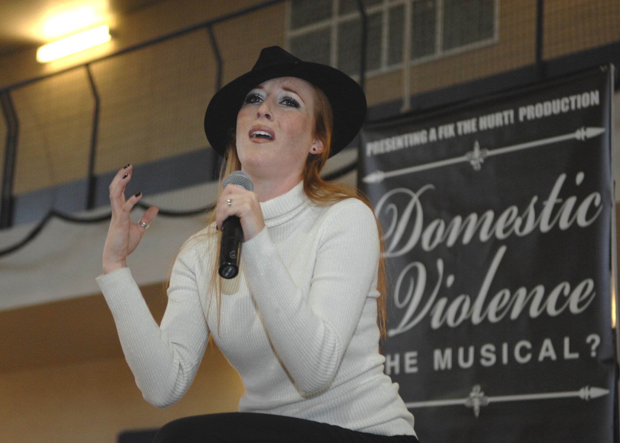 Ginny Green plays the victim during the Domestic Violence Musical held at the Fitness and Sports Center at Holloman Air Force Base, N.M., October 24. Ms. Green depicts the role of a woman in an abusive relationship who struggles to find a way out. (U.S. Air Force photo/Airman 1st Class Veronica Salgado)