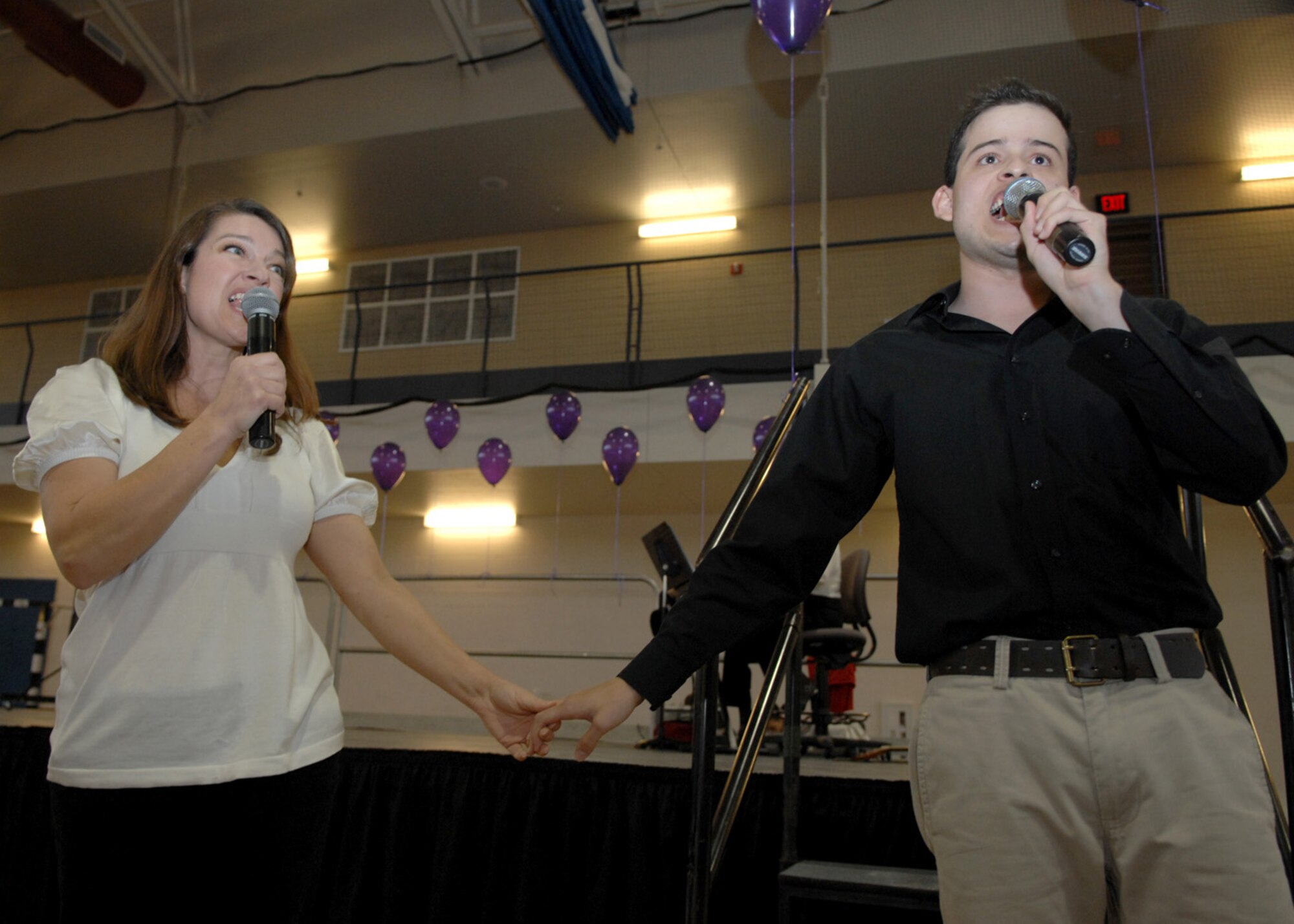 Actors, Cindy Miles and Carlos De La Garza-Garcia, sing about the advantages of being abusers during the Domestic Violence Musical held at the Fitness and Sports center at Holloman Air Force Base, N.M., October 24. The play demonstrated both views of an abusive relationship. (U.S. Air Force photo/Airman 1st Class Veronica Salgado)
