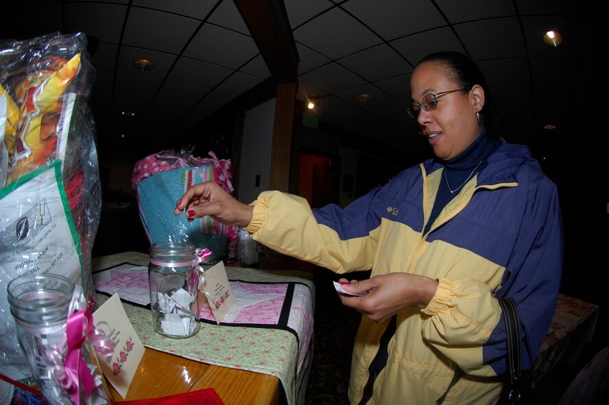 MINOT AIR FORCE BASE, N.D. -- Robin Haddox, 91st Missile Operations Squadron, participates in a basket drawing during the 4th Annual Breast Cancer Awareness Event and Quilt Project at the Jimmy Doolittle Center here Oct. 23. The quilt auction and basket drawings raised almost $10,000. Breast cancer is the second-leading cause of cancer death in women, and more than 40,000 women will die from the disease this year. (U.S. Air Force photo by Airman 1st Class Jesse Lopez)