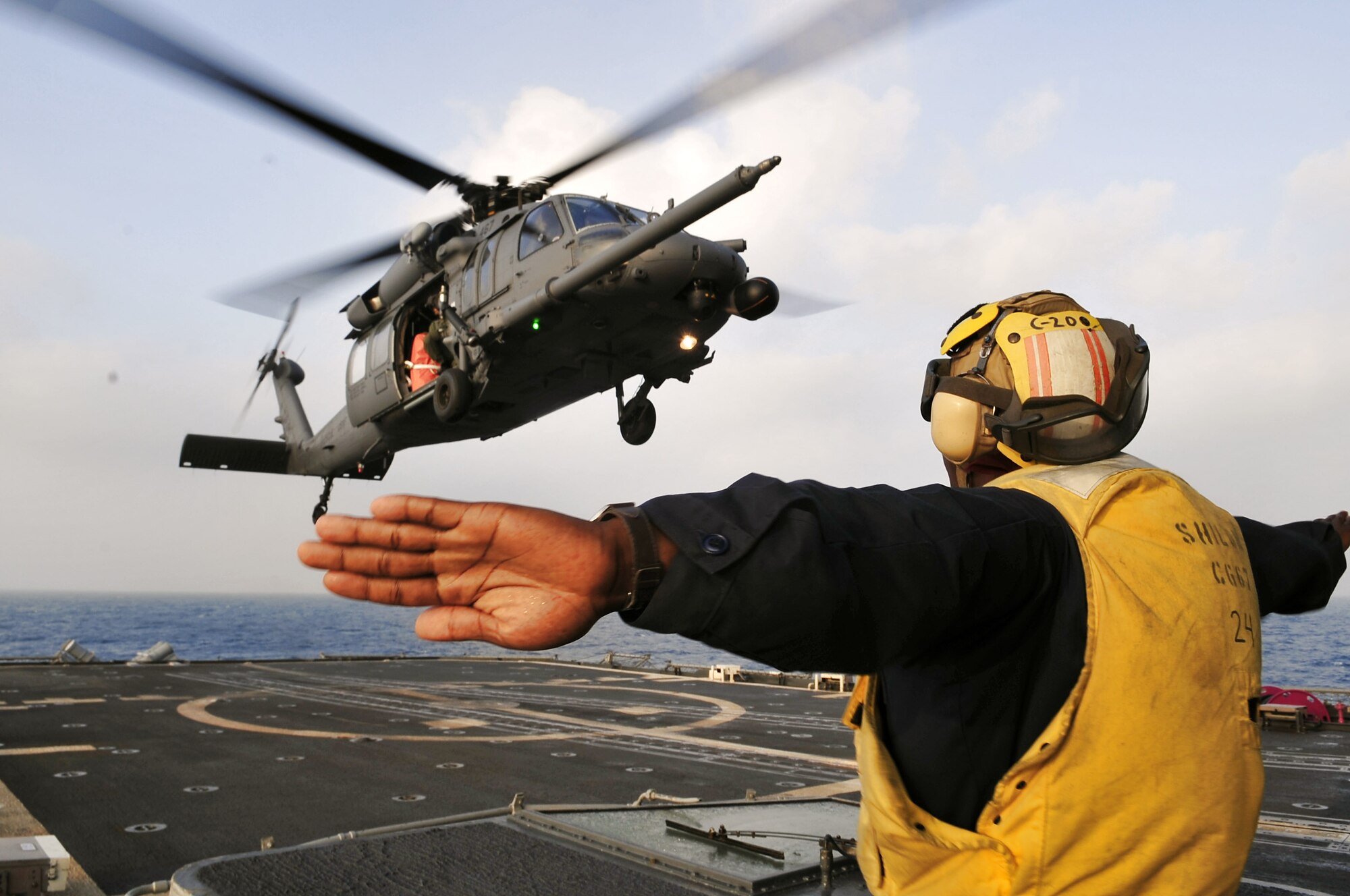 An HH-60G Pave Hawk from the Alaska Air National Guard's 210th Rescue Squadron performs deck landing qualifications aboard the forward-deployed guided-missile cruiser USS Shiloh during preparations for Hong Kong Search and Rescue Exercise 2008 Oct. 26 off the coast of Hong Kong. The annual exercise involved units from the U.S., Hong Kong and the People's Republic of China. (U.S. Navy photo/Petty Officer 1st Class Michael B. Watkins) 