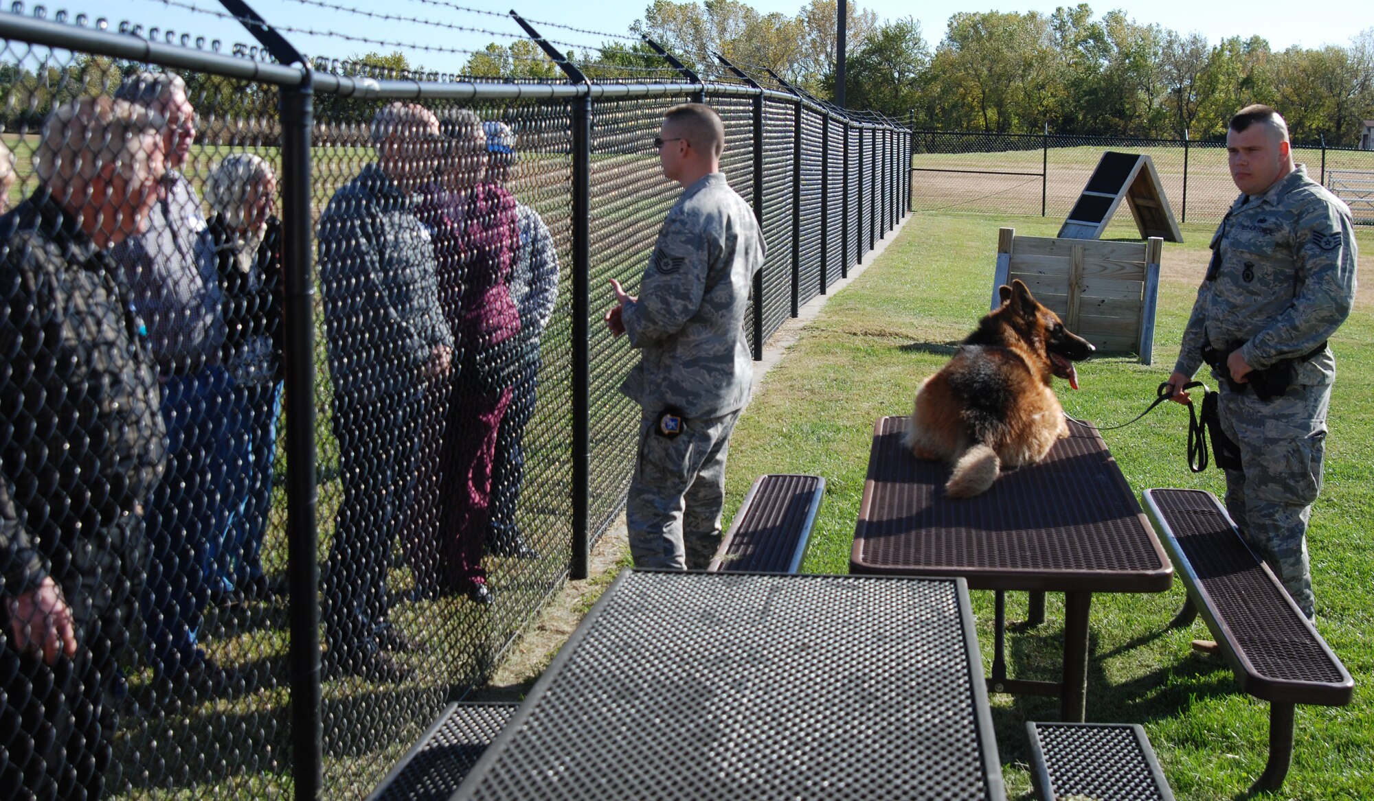 MCCONNELL AIR FORCE BASE, Kan. -- Tech Sgt. Andrew Bedell and Staff Sgt. Matthew Ellgen and his military working dog, Atom, 22nd Security Forces Squadron, answer questions from military retirees during a dog demonstration on Military Retiree Appreciation day, Oct 25. (Photo by Airman 1st Class Jessica Lockoski)