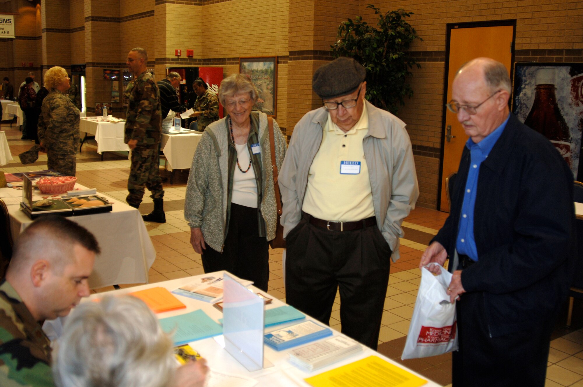 MCCONNELL AIR FORCE BASE, Kan. -- Military retirees gather around display tables which offer advice on veterans’ services and information on base agencies, Oct. 25, during Military Retiree Appreciation day at the Robert J. Dole Center.   (Photo by Master Sgt. Christopher Wuerthner )