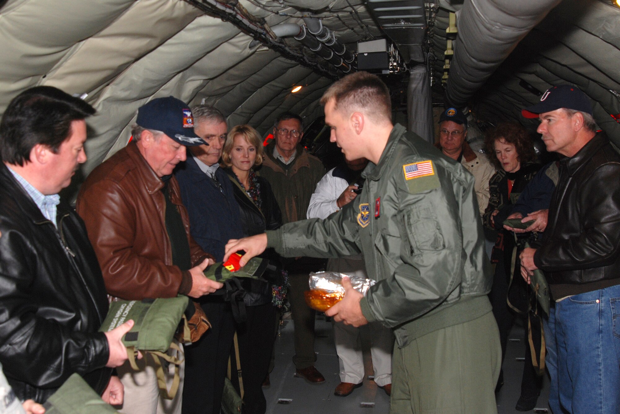 MCCONNELL AIR F ORCE BASE, Kan. -- Airman 1st Class Chad McHenry, 350th Air Refueling Squadron boom operator, shows honorary commanders how to use an emergency passenger oxygen system in the event of an in-flight emergency, prior to an honorary commander orientation flight, Oct. 23. (Photo by Airman 1st Class Jessica Lockoski)