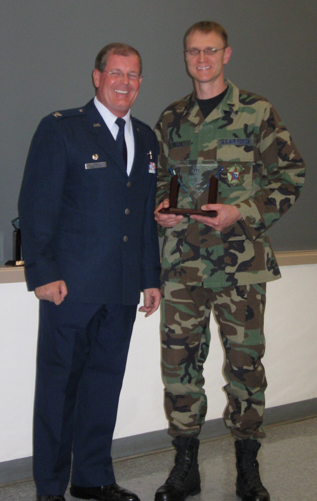 1st Lt. Rolf Miller, 26th Space Aggressor Squadron, receives his award as Company Grade Officer of the Half during Commander's Call on Oct. 25.
