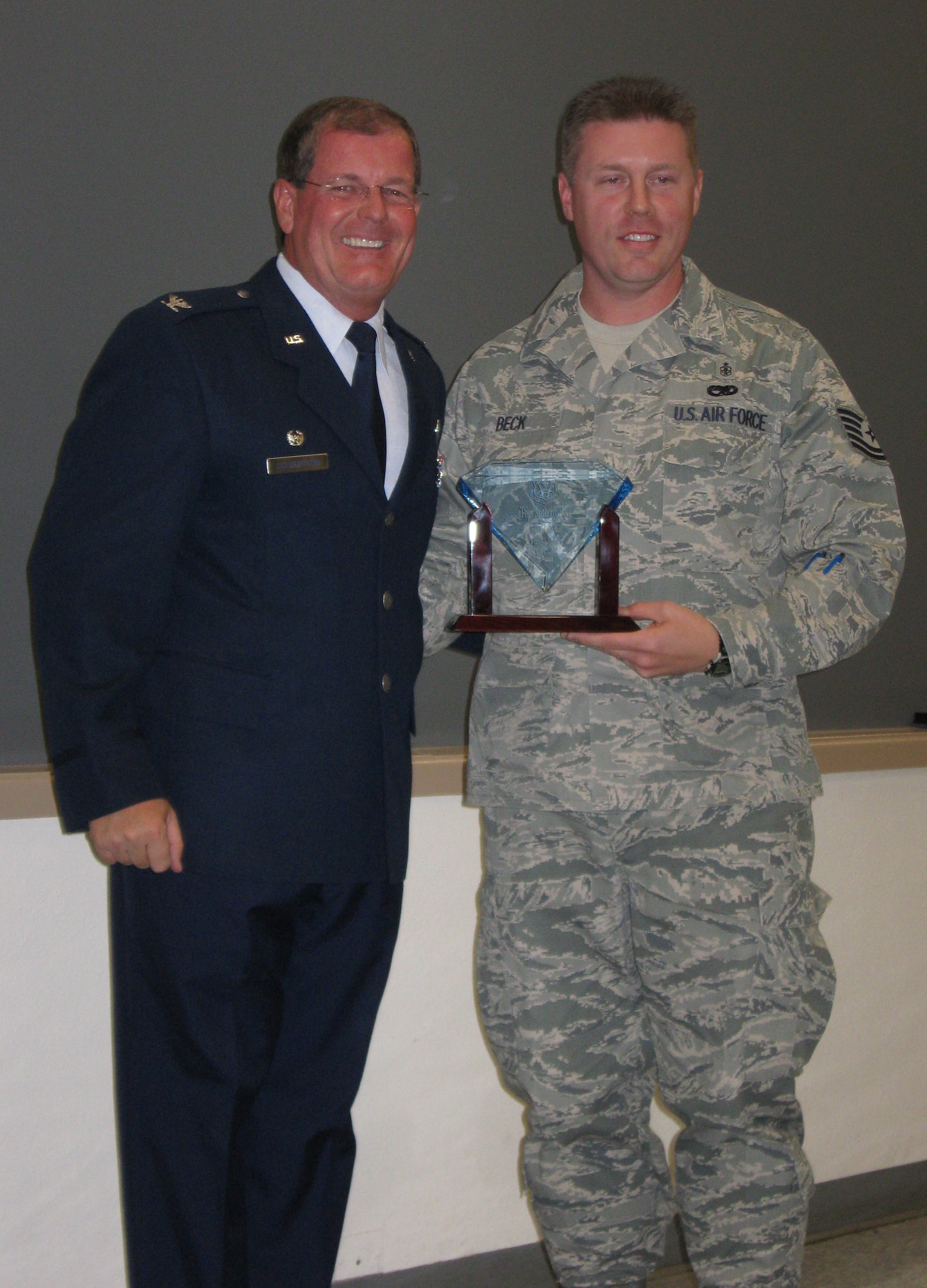 Tech. Sgt. Anthony Beck, 926th Aerospace Medicine Flight, receives his award as Noncommissioned Officer of the Half during Commander's Call on Oct. 25.