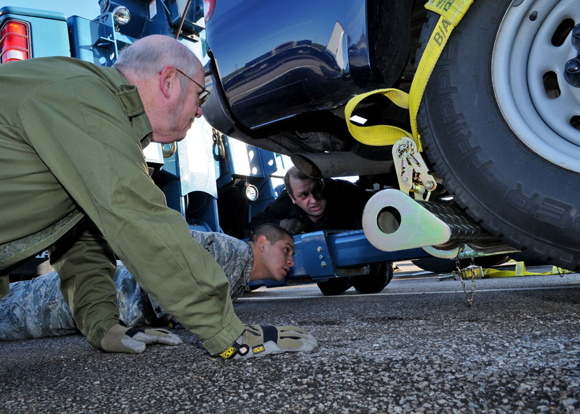 Mr. John Lake (left) and Airman Jonathan Loera (center) both 100th Logistics Readiness Squadron vehicle operators, watch as Dave Green (right), the training manager for the vehicle operations section, explains proper placement of the tow vehicle prior to lifting a truck during wrecker training Oct. 27, 2008. The training was held to certify and give hands on experience to vehicle operators for proper use and basic knowledge of using the Wrecker vehicles. (U.S. Air Force photo by Staff Sgt. Jerry Fleshman) 