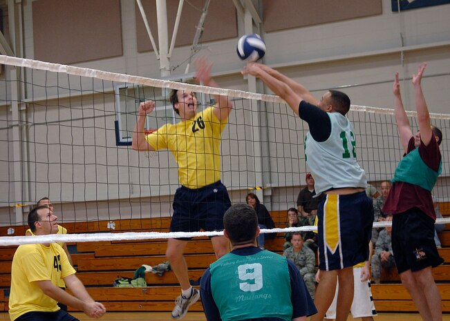 Dennis Wells blocks the hit from the APS team during the volleyball championship match on base Oct. 23. The AMXS team defeated APS 24-26, 25-16 and 15-10 to win the championship. Wells is from the 437th Aircraft Maintenance Squadron. (U.S. Air Force photo/Airman 1st Class Katie Gieratz)