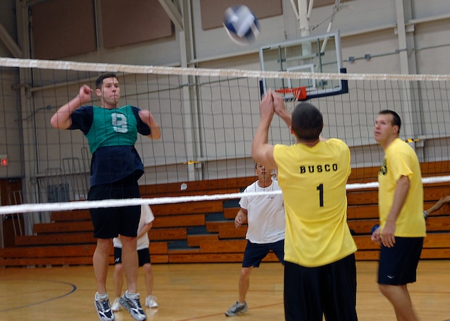 John Busco hits the ball to the AMXS team as Branndon Teffeteller prepares to block it during the volleyball championship match on base Oct. 23. The AMXS team defeated the APS team 24-26, 25-16 and 15-10 to win the championship. Busco is from the 437th Aerial Port Squadron and Teffeteller is from the 437th Contracting Squadron. (U.S. Air Force photo/Airman 1st Class Katie Gieratz)

