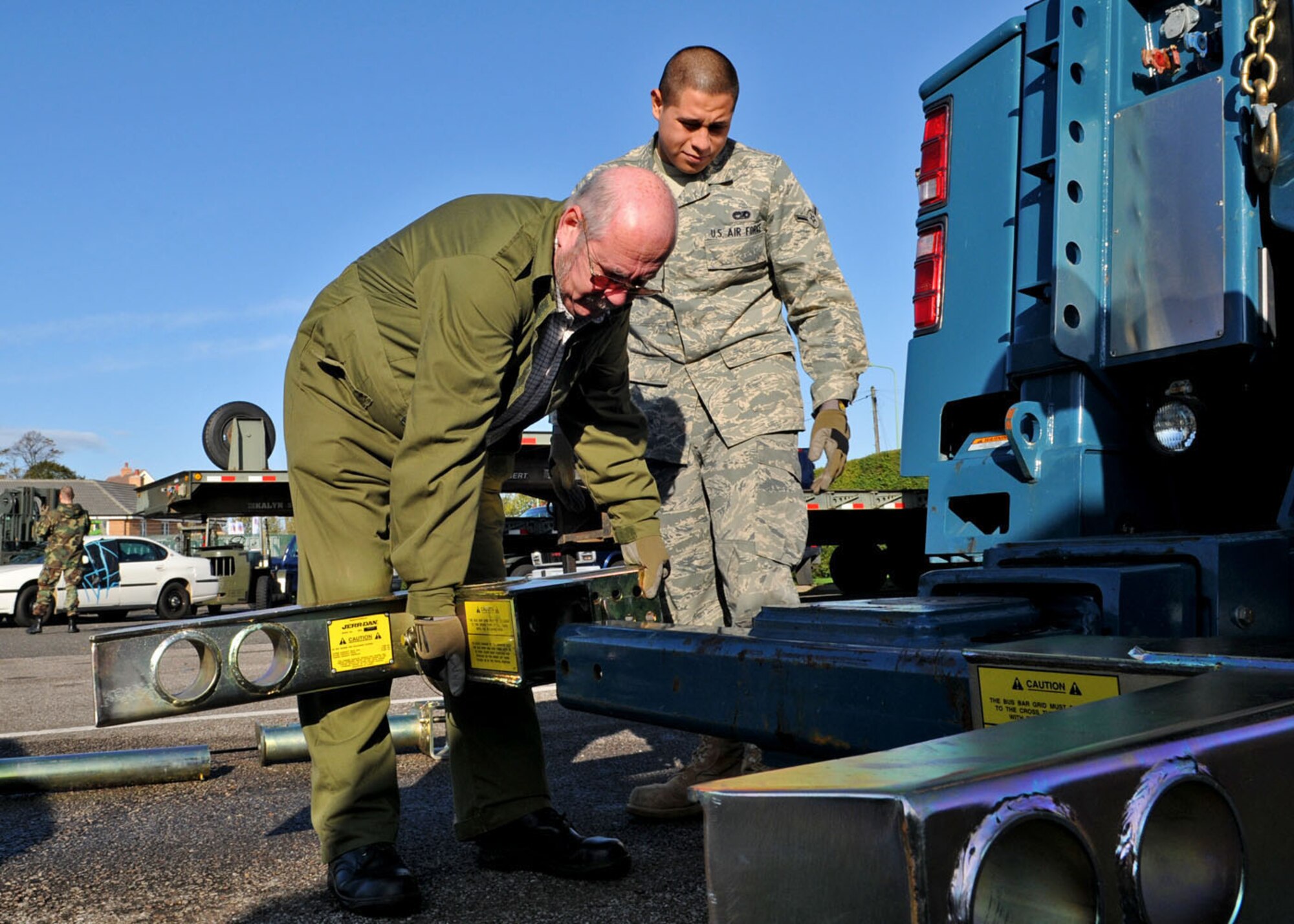 John Lake, 100th Logistics Readiness Squadron vehicle operator, installs a bus bar grid to a cross tube, while Airman Jonathan Loera, also a 100th LRS vehicle operator, looks on during 35-ton recovery training (commonly referred to as wrecker training) Oct. 27, 2008. The training, at RAF Mildenhall, England, was held to certify and give hands on experience to vehicle operators for the proper use and basic knowledge of using the Wrecker vehicles. (U.S. Air Force photo by Staff Sgt. Jerry Fleshman)