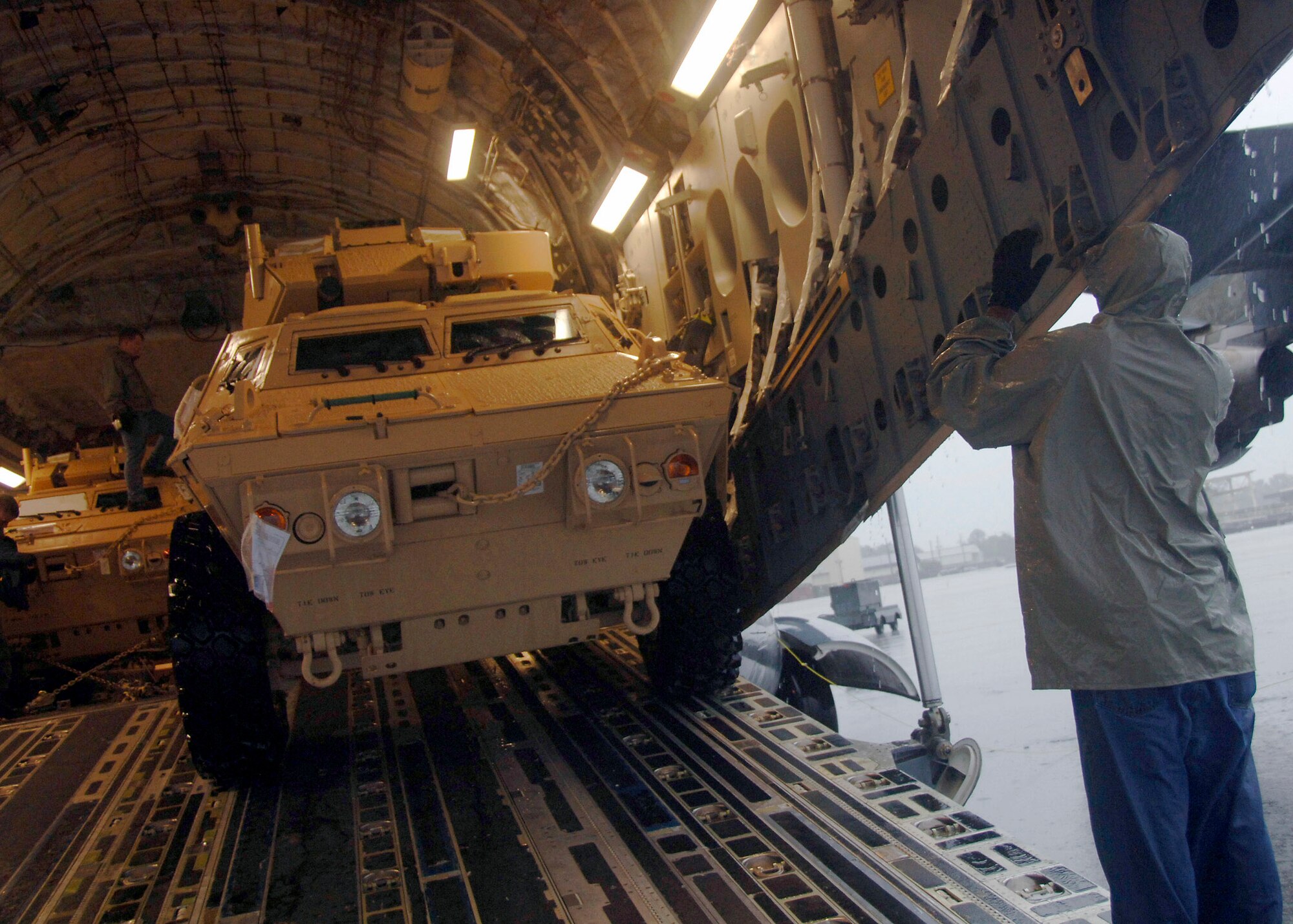 Corrie Frazier guides an armored security vehicle toward the back of a C-17 on the Charleston AFB flightline Oct. 24. The Armored Security Vehicle is a four-wheel-drive vehicle that provides ballistic protection to warfighters who are using them against various threats. Mr. Frazier is with the 437th Aerial Port Squadron. (U.S. Air Force photo/Airman 1st Class Timothy Taylor)
