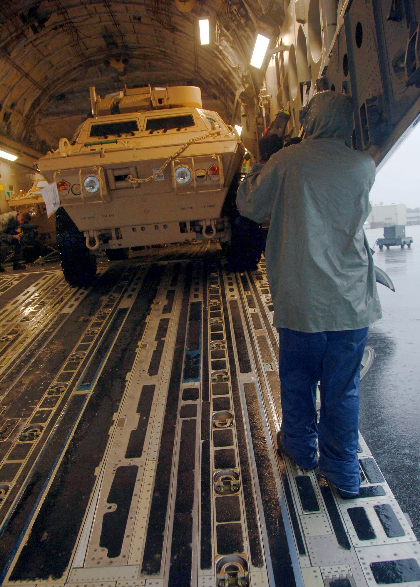 Corrie Frazier guides an armored security vehicle toward the back of a C-17 on the Charleston AFB flightline Oct. 24. The Armored Security Vehicle is a four-wheel-drive vehicle that provides ballistic protection to warfighters who are using them against various threats. Mr. Frazier is with the 437th Aerial Port Squadron. (U.S. Air Force photo/Airman 1st Class Timothy Taylor)
