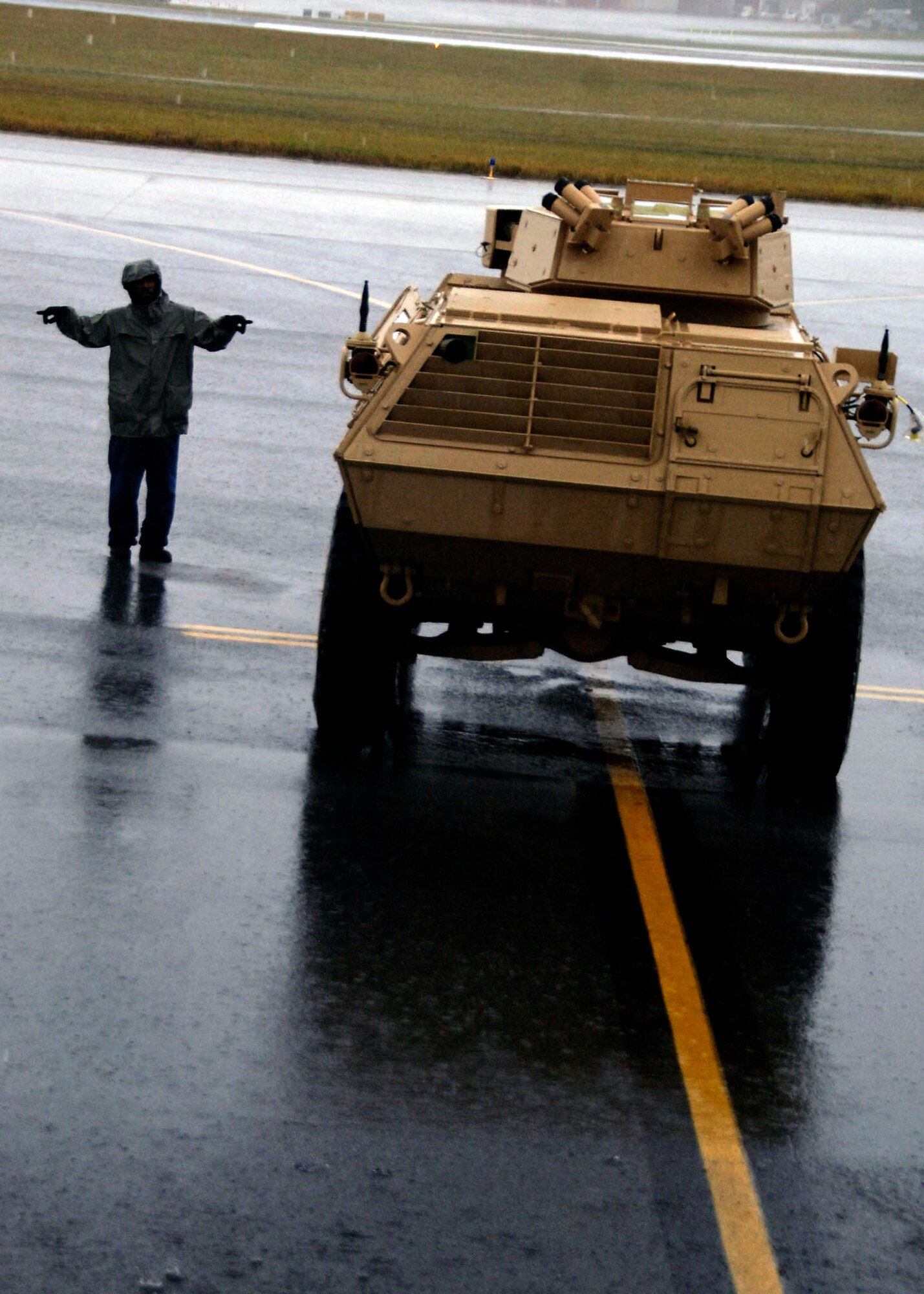 Corrie Frazier guides an armored security vehicle toward the back of a C-17 Globemaster III Oct. 24 at Charleston Air Force Base, S.C. The ASV is a four-wheel-drive vehicle that provides ballistic protection to warfighters who are using them against various threats. Mr. Frazier is with the 437th Aerial Port Squadron. (U.S. Air Force photo/Airman 1st Class Timothy Taylor)

