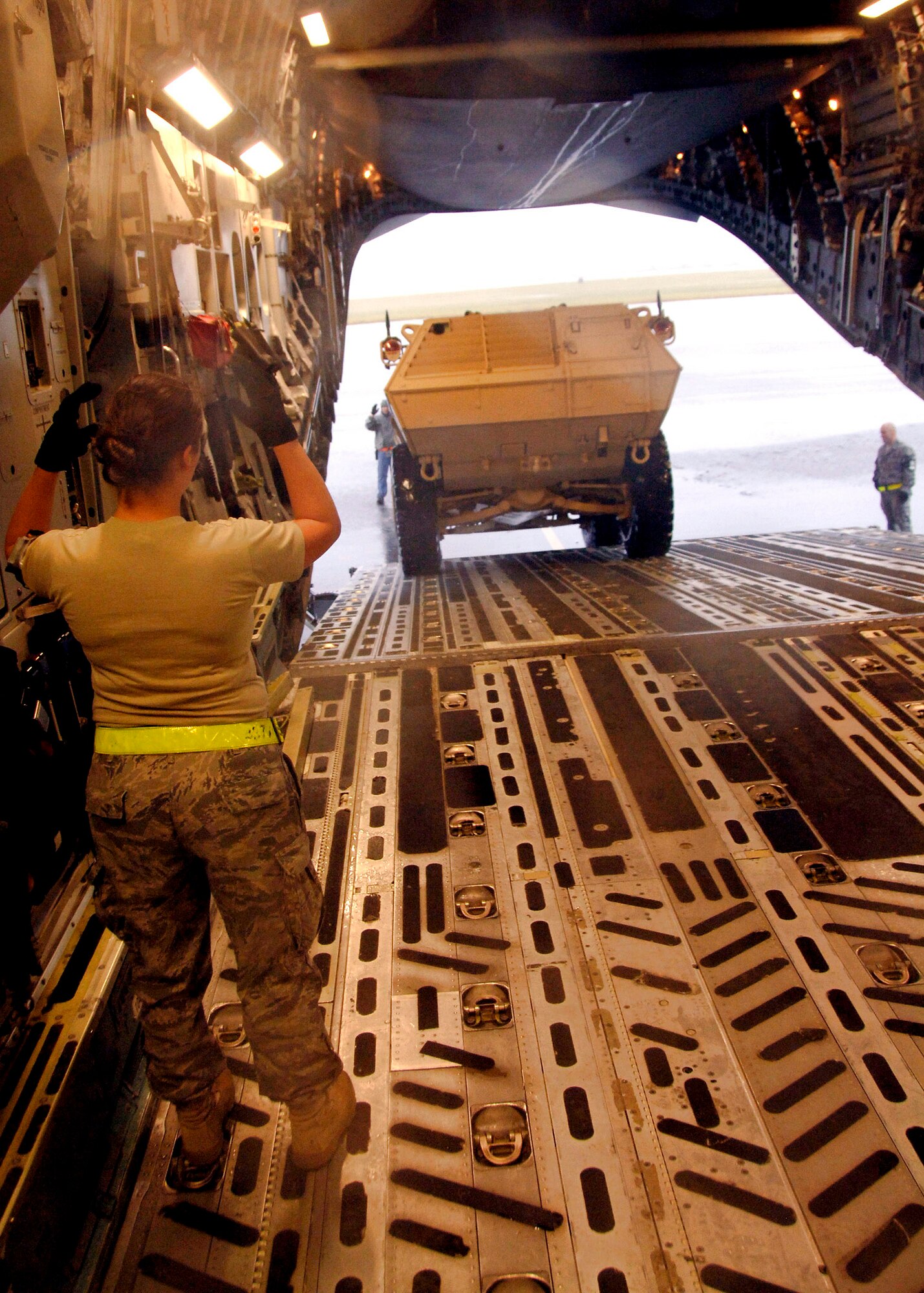 Senior Airman Ashley Kelly guides an M1117 armored security vehicle onto a C-17 Globemaster III Oct. 24 at Charleston Air Force Base, S.C. The ASV is a four-wheel-drive vehicle that provides ballistic protection to warfighters who are using them against various threats. Airman Kelly is assigned to the 437th Aerial Port Squadron. (U.S. Air Force photo/Airman 1st Class Timothy Taylor)