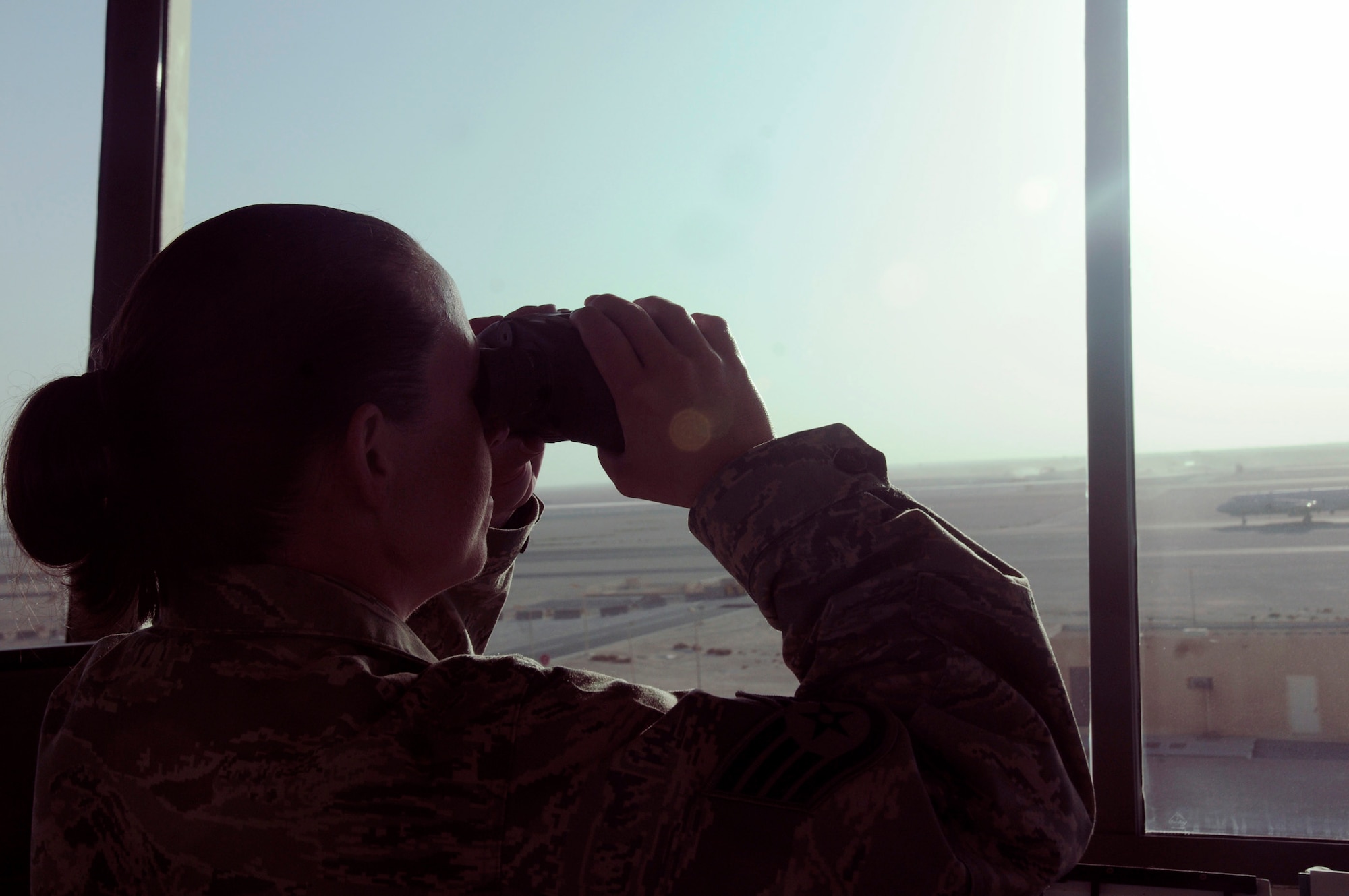 Staff Sgt. Sandra Trull, air traffic controller specialist assigned to the 379th Expeditionary Operations Support Squadron, looks through binoculars to check a mechanical problem on an aircraft Oct. 20, 2008 at an undisclosed location in Southwest Asia. A three-person team of air traffic controllers ensures the safety of more than 1,200 operations weekly by following ATC guidelines. Sergeant Trull, a native of Asheville, N.C., is deployed from McEntire Joint National Guard Base Columbia, S.C. (U.S. Air Force photo by Staff Sgt. Darnell T. Cannady)