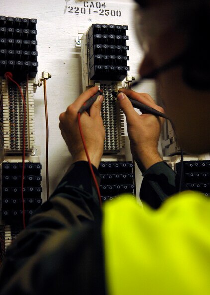 BARKSDALE AIR FORCE BASE, La.-- Airman 1st Class Ezekiel Newman, 2d Communication Squadron, tests for stray voltage to ensure the cables lines are serviceable. The 2CS plays a vital role in daily communications by ensuring that every Airmen of Barksdale Air Force Base has communication access. (U.S. Air Force photo by Airman 1st Class Brittany Y. Bateman)