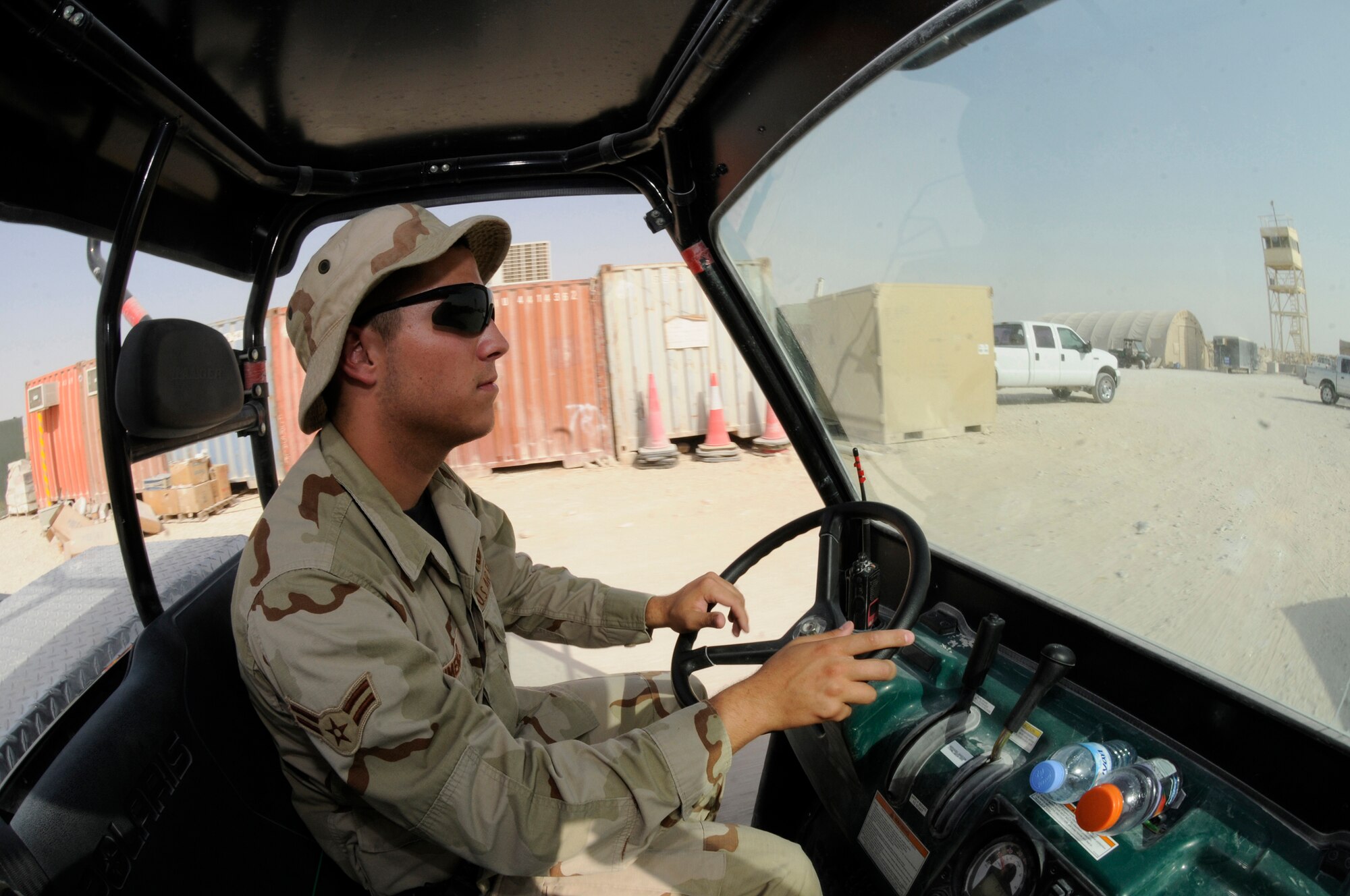 Airman 1st Class John Jimenez, assigned to the electric shop of the 379th Expeditionary Civil Engineer Squadron, drives a utility vehicle back to the shop to pick up supplies for the job site, October 28.  The electricians are installing new lighting outside of the post office at an undisclosed air base in Southwest Asia.  Airman Jimenez, a native of Oceanside, Calif., is deployed from Fairchild Air Force Base, Wash., supporting Operations Iraqi and Enduring Freedom and Joint Task Force-Horn of Africa.  (U.S. Air Force photo by Tech. Sgt. Michael Boquette/Released)