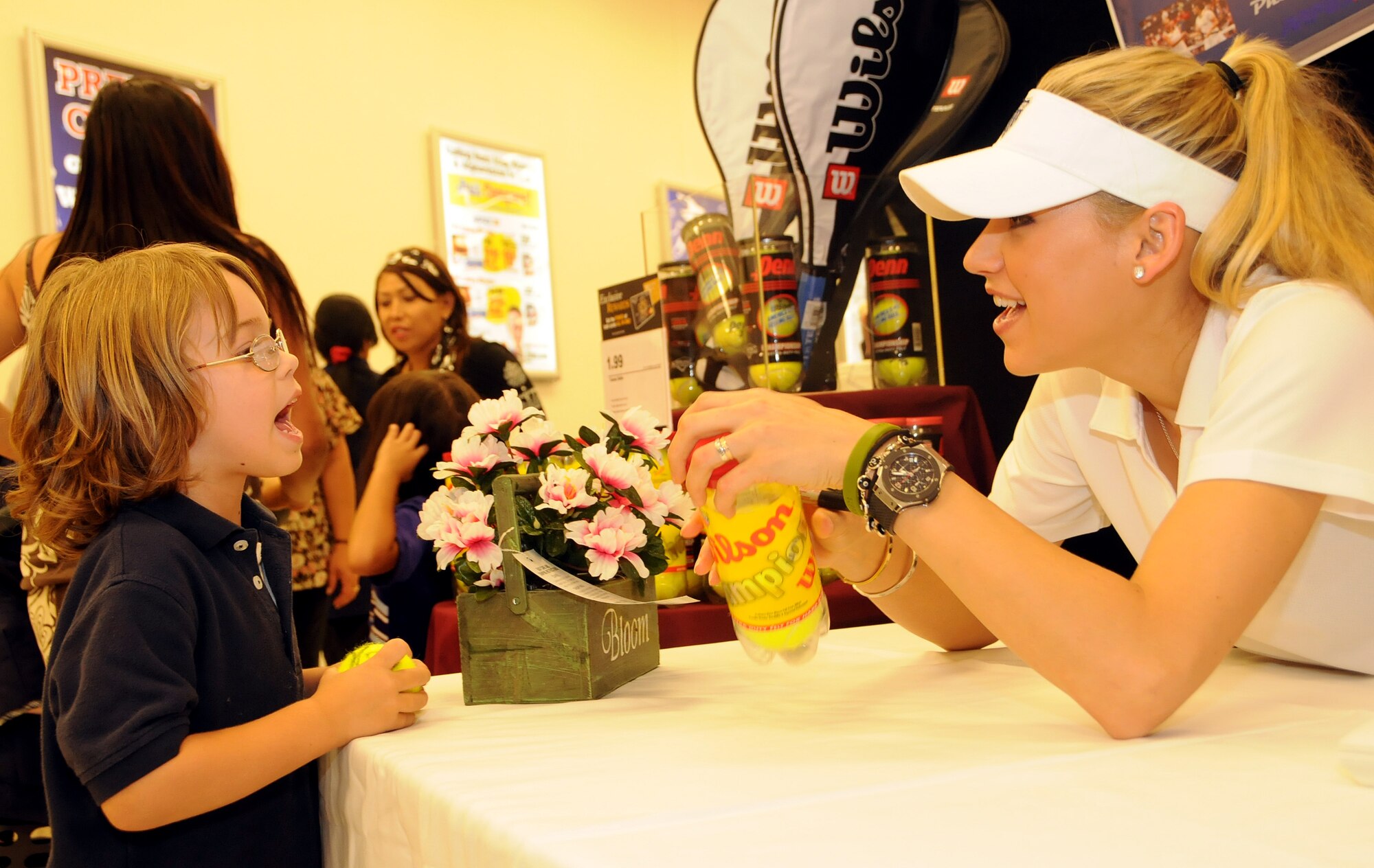 ANDERSEN AIR FORCE BASE, Guam - Anna Kournikova signs an autograph for six-year old Keegan Hart at a booth in the Base Exchange here Oct. 29. Keegan son of Tech. Sgt. Christopher Hart, 734th Air Mobility Squadron and Mrs. Jaye Hart thanks Ms. Kournikova for visitng the island. (U.S. Air Force photo by Airman 1st Class Courtney Witt)
