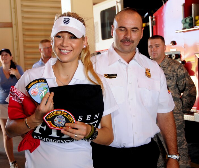 ANDERSEN AIR FORCE BASE, Guam - Anna Kournikova accepts a gift from the Fire and Emergency Services Flight Fire Chief John Thompson here Oct. 29. She is here on a tour sponsored by the USO to boost moral of the military members on Guam. (U.S. Air Force photo by Airman 1st Class Courtney Witt)
