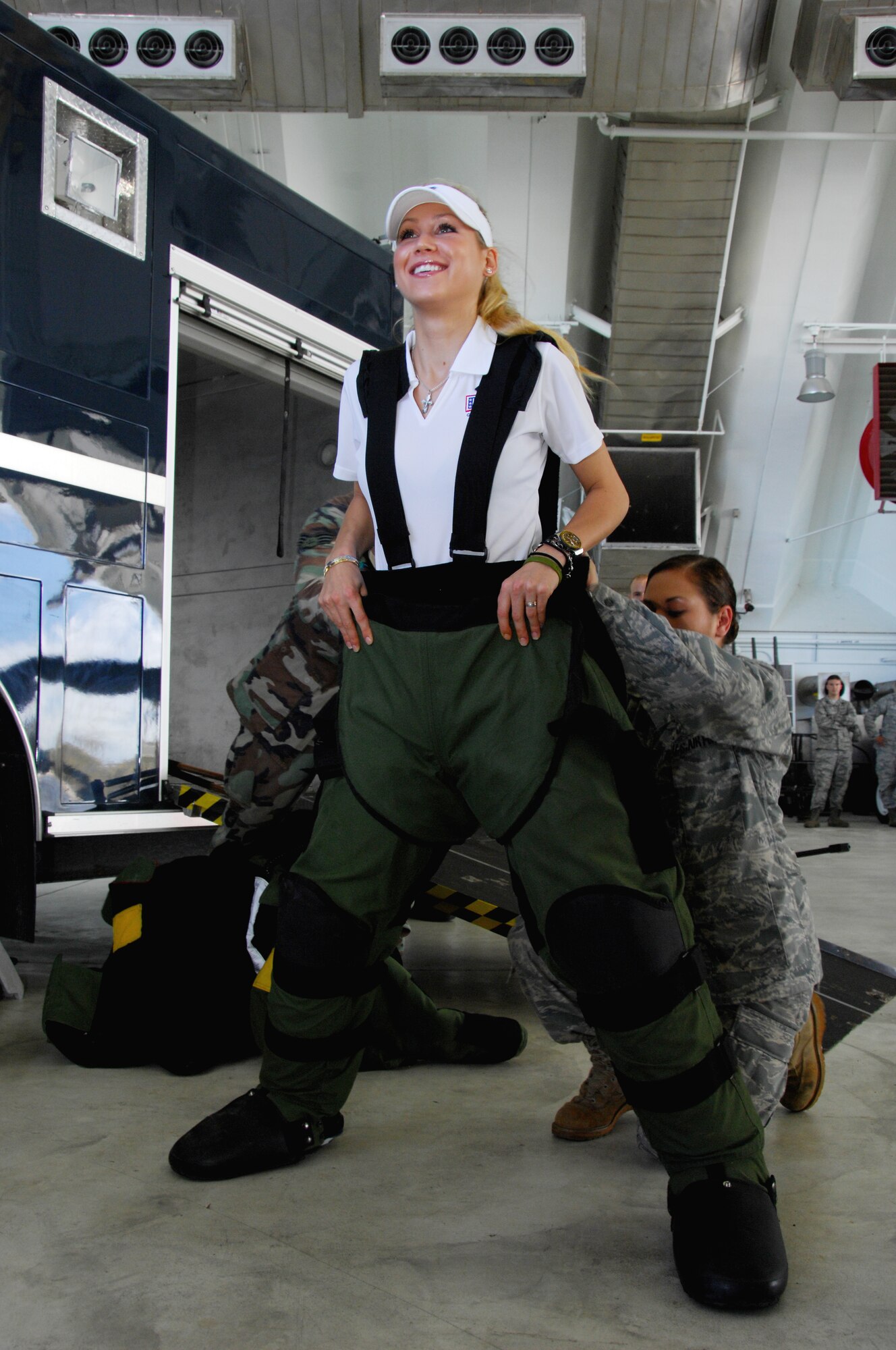 ANDERSEN AIR FORCE BASE, Guam - Staff Sgt. Sherri Streu, 36th Civil Engineer Squadron helps Ms. Anna Kournikova put on the Explosive Ordnances Disposal-9 Bombsuit, while touring here at Hangar 1 Oct. 29.  The  Explosive Ordnances Disposal-9 Bombsuit is used by EOD to prevent injuries and even death during the disposal of explosive ordnances. (U.S. Air Force photo by Airman 1st Class Nichelle Griffiths)