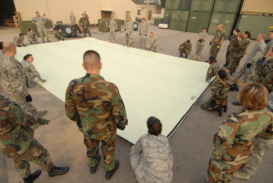 KUNSAN AIR BASE, Republic of Korea -- Airman from Luke Air Force base, Ariz. and Westover Air Force Base, Mass. construct a madical staging facility here, Oct. 21. The Airman are medical reservist who are deployed here for training. (U.S. Air Force photo/Senior Airman Gustavo Gonzalez)