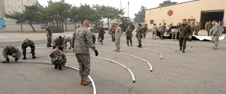 KUNSAN AIR BASE, Republic of Korea -- Airman from Luke Air Force Base, Ariz. and Westover Air Force Base, Mass. construct a madical staging facility here, Oct. 21. The Airman medical reservist who are deployed here for training. (U.S. Air Force photo/Senior Airman Gustavo Gonzalez)