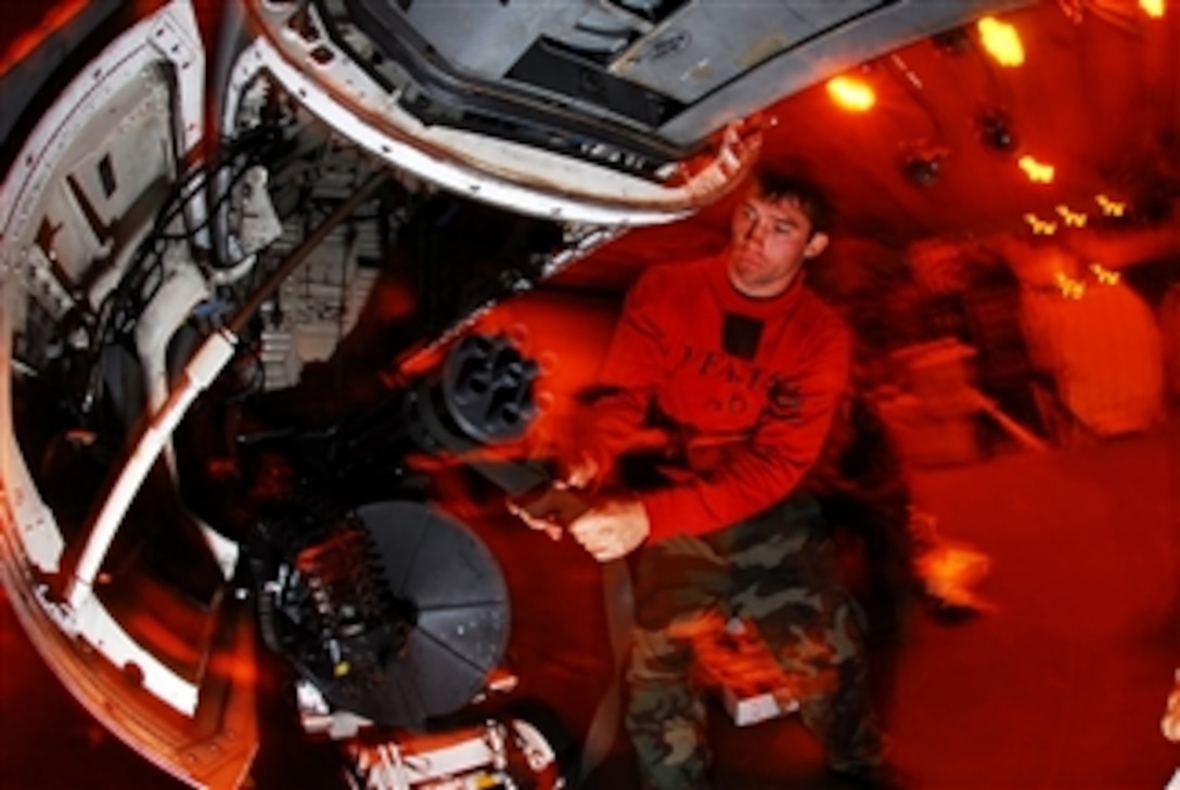 U.S. Navy Petty Officer 2nd Class Hunter Owens reinstalls an M-61A1 20-mm Gatling gun in the gun bay of an F/A-18C Hornet aircraft assigned to Strike Fighter Squadron 146 during routine maintenance in the hangar bay aboard the aircraft carrier USS John C. Stennis (CVN 74) while underway in the Pacific Ocean on Oct. 26, 2008.  The Stennis and embarked Carrier Air Wing 9 are conducting a composite training unit exercise off the coast of southern California.  