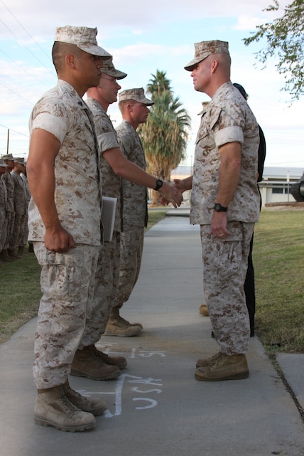 Marines stand at attention while Lt. Col. Thomas Gordon, 1st Tank Battalion commanding officer, and Gene Berbaum, the president of the Marine Corps Tankers Scholarship Foundation, award and congratulate them on receiving the Tanker of the Year awards during the unit’s birthday and Tanker of the Year award ceremony outside the battalion headquarters Oct. 31.