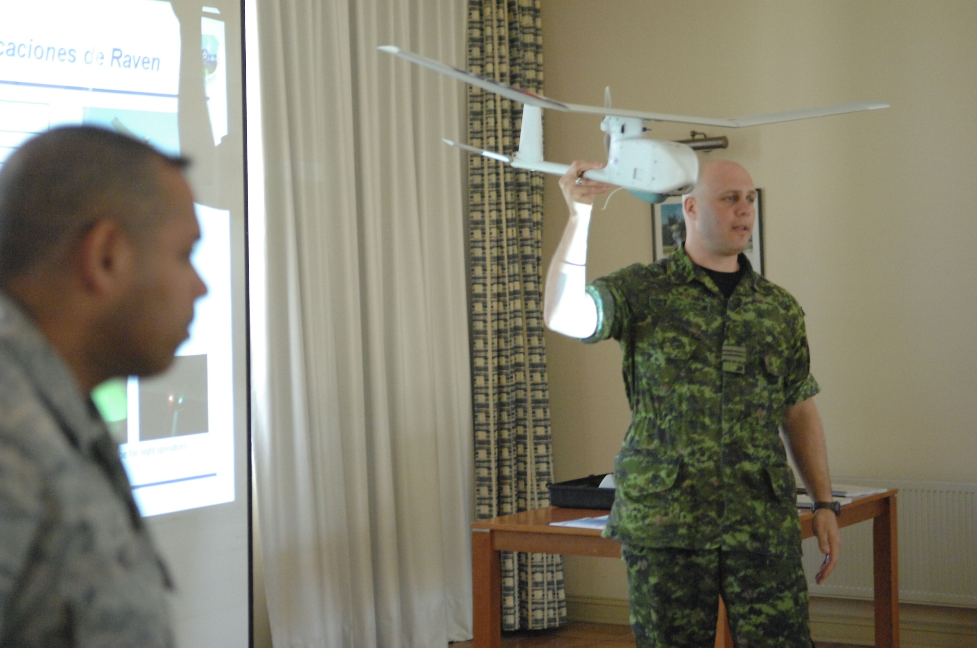 Canadian army Maj. Brian Nekurak (right) an officer in the foreign exchange program, demonstrates the use and capabilities of the small, unmanned aerial system Oct. 29 while Master Sgt. Edward Nin translates Major Nekurak's words into Spanish at Quintero Air Base, Chile during Operation Southern Partner. Operation Southern Partner is an in-depth, two-week subject matter exchange emphasizing partnership, cooperation and sharing of information with partner nation Air Forces  in Latin America. 
(U.S. Air Force Photo by TSgt Roy Santana, Released)