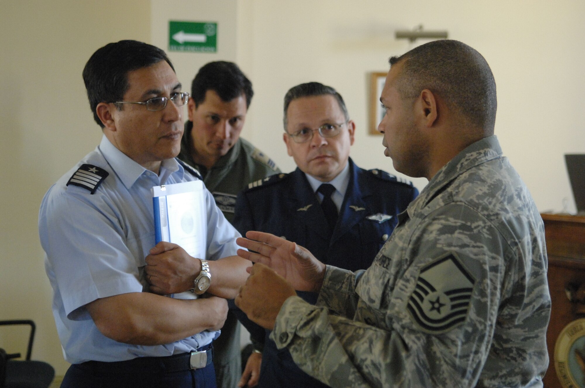 Master Sgt. Edward Nin, a force protection noncommissioned officer from 12th Air Force at Davis Monthan Air Force Base, Ariz., discusses highlights of an Oct. 29 Operation Southern Partner subject matter exchange with the Chilean air base chief of security forces Col. Randot Espinoza, while the group Commandant, Col. Anselmo Salas (center) looks on. Operation Southern Partner is an in-depth, two-week subject matter exchange emphasizing partnership, cooperation and sharing of information with partner nation Air Forces in Latin America. (U.S. Air Force Photo/Tech. Sgt. Roy Santana)