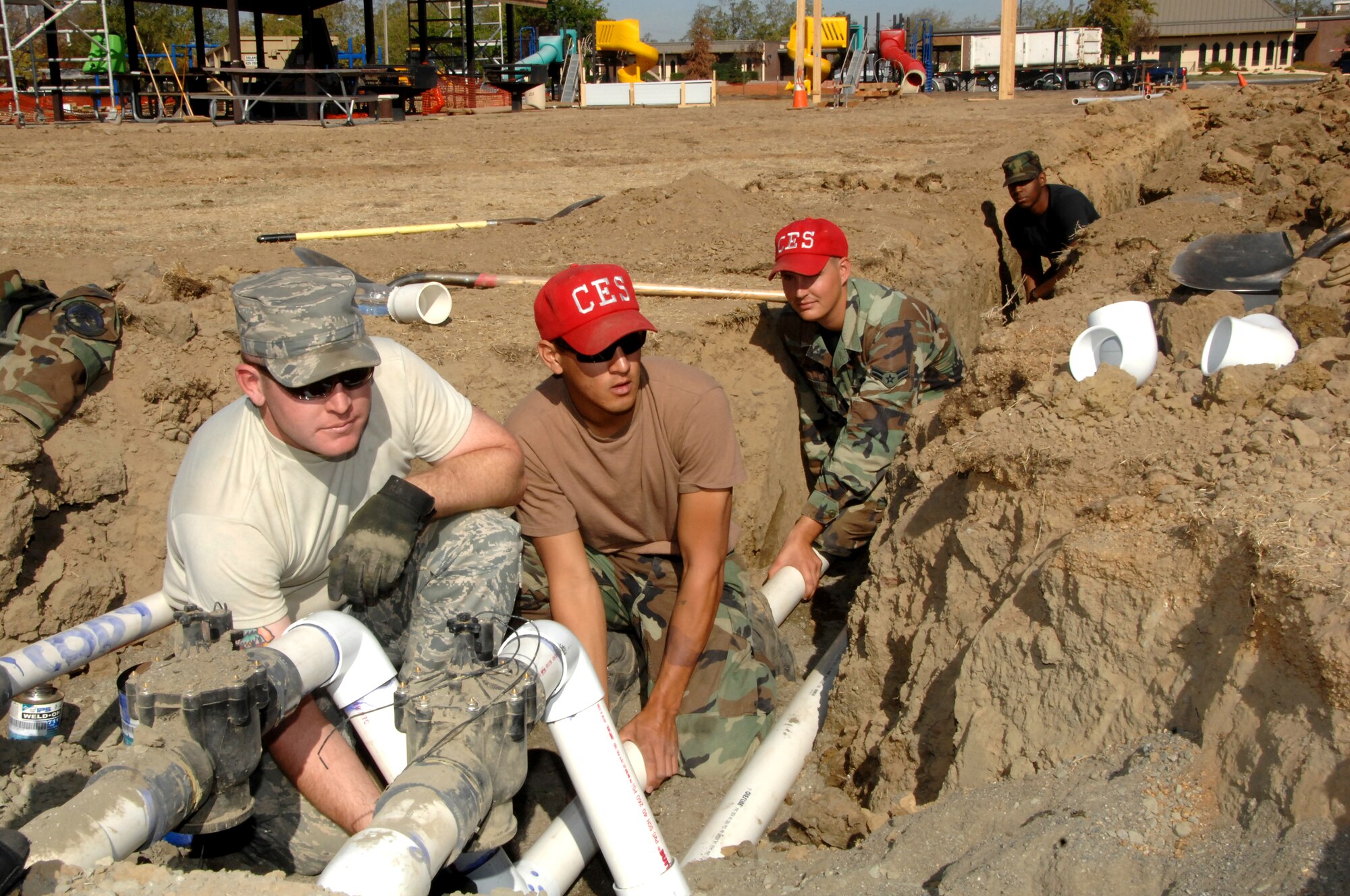 From left, Staff Sgt. David O?bryant and Airmen 1st Class Cody Kincaid, Brandon Weldy and Matthew Weber, 60th Civil Engineering Squadron, work to refurbish the Travisville Park here. (U.S. Air Force photo/Amanda Lopez)