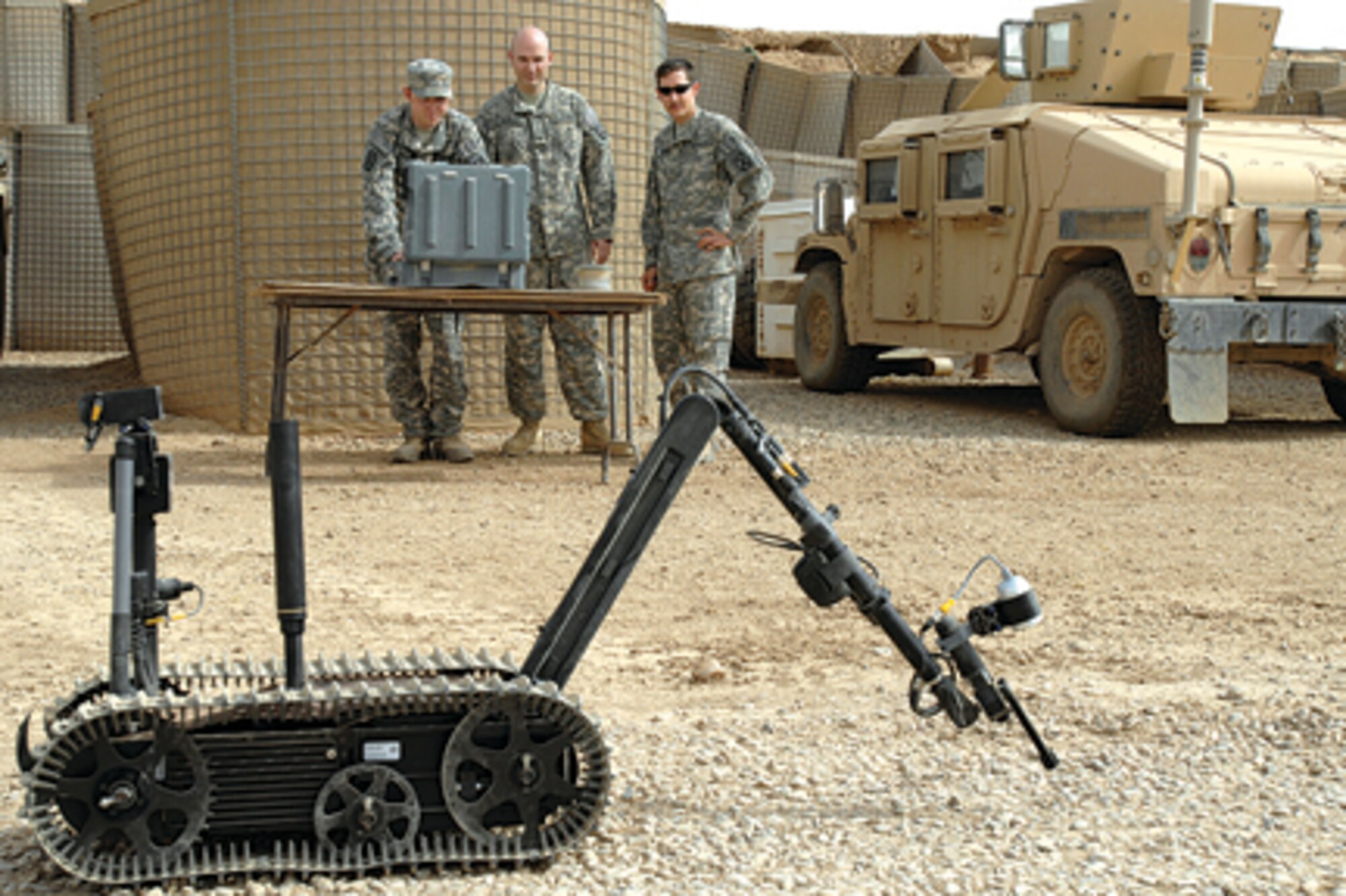 Senior Airman Aaron Skelton, Tech, Sgt. Stephen Ray Hunter Jr., and Senior Airman Joshua Brum, 506th Air Expeditionary Group Explosive Ordanance Disposal flight members, run a funtion check on a TALON robot Sept. 14. The teams use the robot ot find and disable roadside bombs. Six Kirkurk Regional Air Base EOD Airmen are forward deployed to forward operation base McHenry where they are embedded with soldiers of the Army's 10th Mountain Division. (U.S. Air Force photo/ Tech. Sgt. Jeff Walston.)