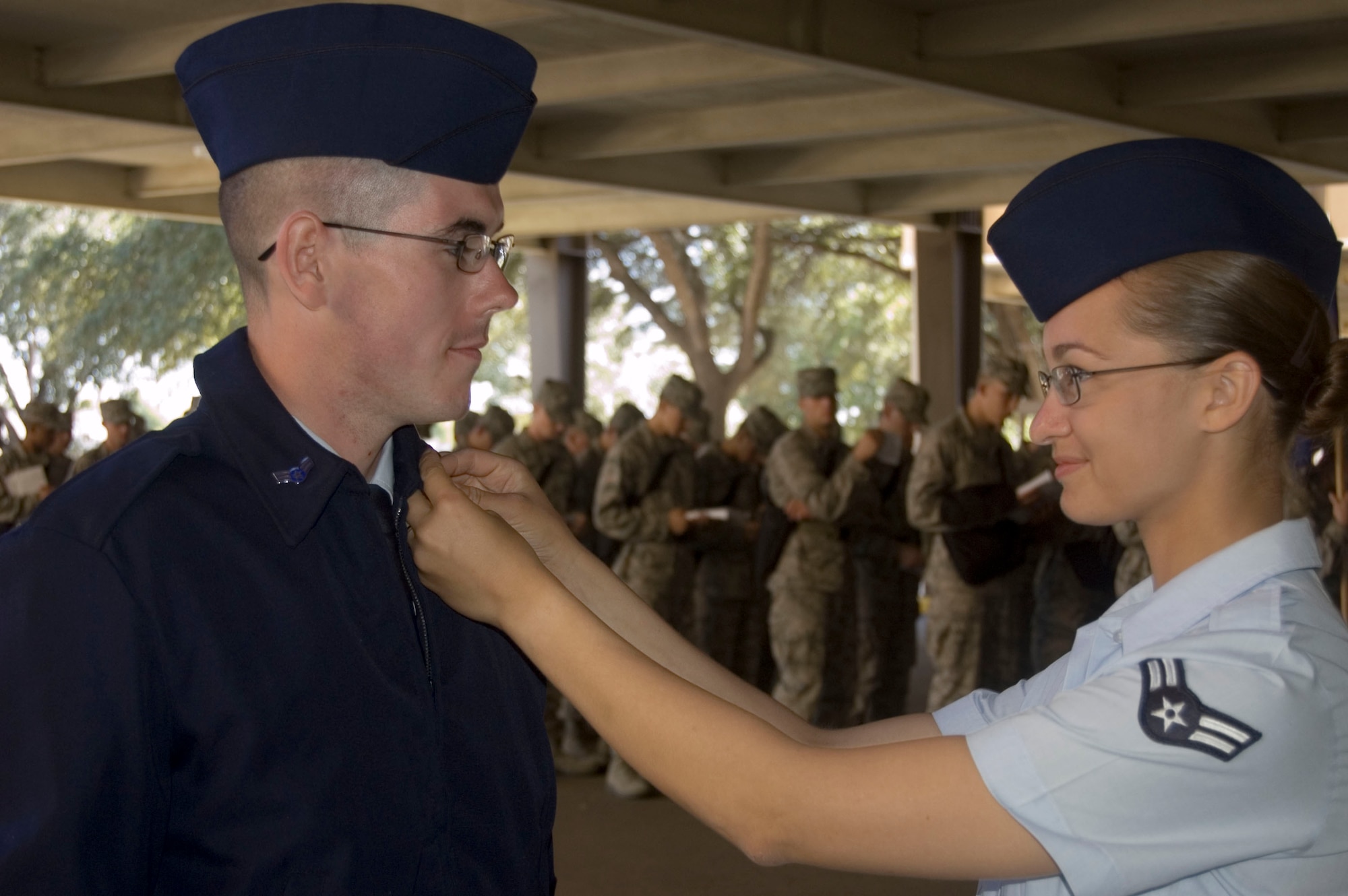 Airman 1st Class Melissa Lafollette admires husband Airman 1st Class Steven Lafollette’s new rank lapel on the day of graduation from basic military training Oct. 24 at Lackland Air Force Base, Texas. The couple were among the 10 percent announced as honor graduates. (U.S. Air Force photo/Tech. Sgt. Matthew McGovern)