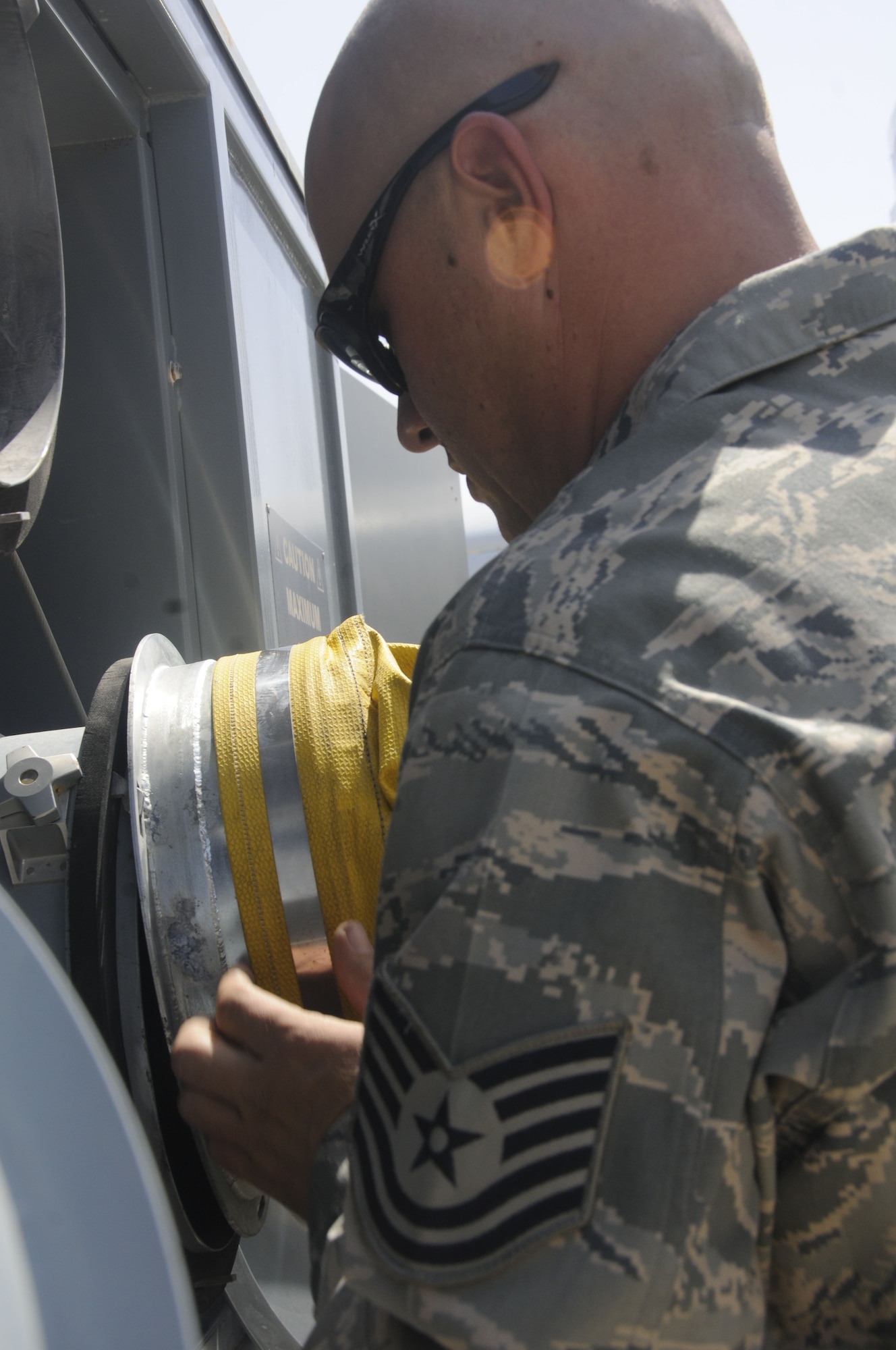 TSgt. Jason Blurton, 642nd Combat Sustainment Group, attaches a duct to a 110-ton flightline diesel air conditioner that provides conditioned air for ground testing of aircraft. Courtesy photo