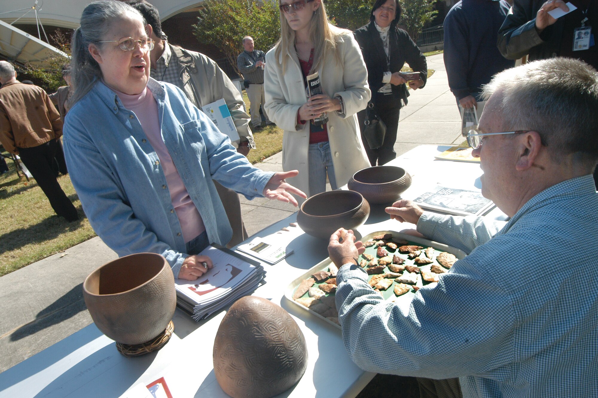 Betty Henderson talks with  David Mincey, Ocumulgee Archeology Society president,about artifacts she and Sandra Henderson have collected during last year's artifact ID day.  U. S. Air Force photo by Sue Sapp  