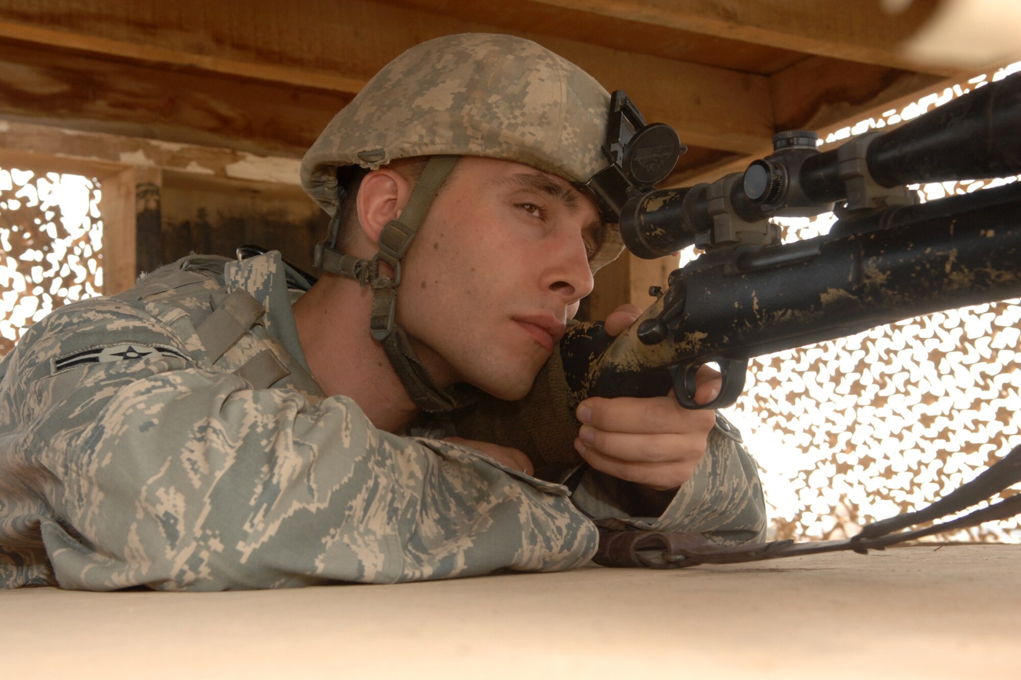 Airman 1st Class Joseph Curran keeps a close eye on activity outside the wire during his deployment to Kirkuk Regional Air Base, Iraq. Airman Curran is assigned to the 71st Security Forces Squadron here at Vance AFB. He was recently selected the 506th Air Expeditionary Group’s “Warrior of the Week.”  At Kirkuk RAB, Airman Curran is part of the 506th Expeditionary Security Forces Squadron close precision engagement team that provides enhanced observation for base defense. (U.S. Air Force photo by Senior Airman Randi Flaugh)