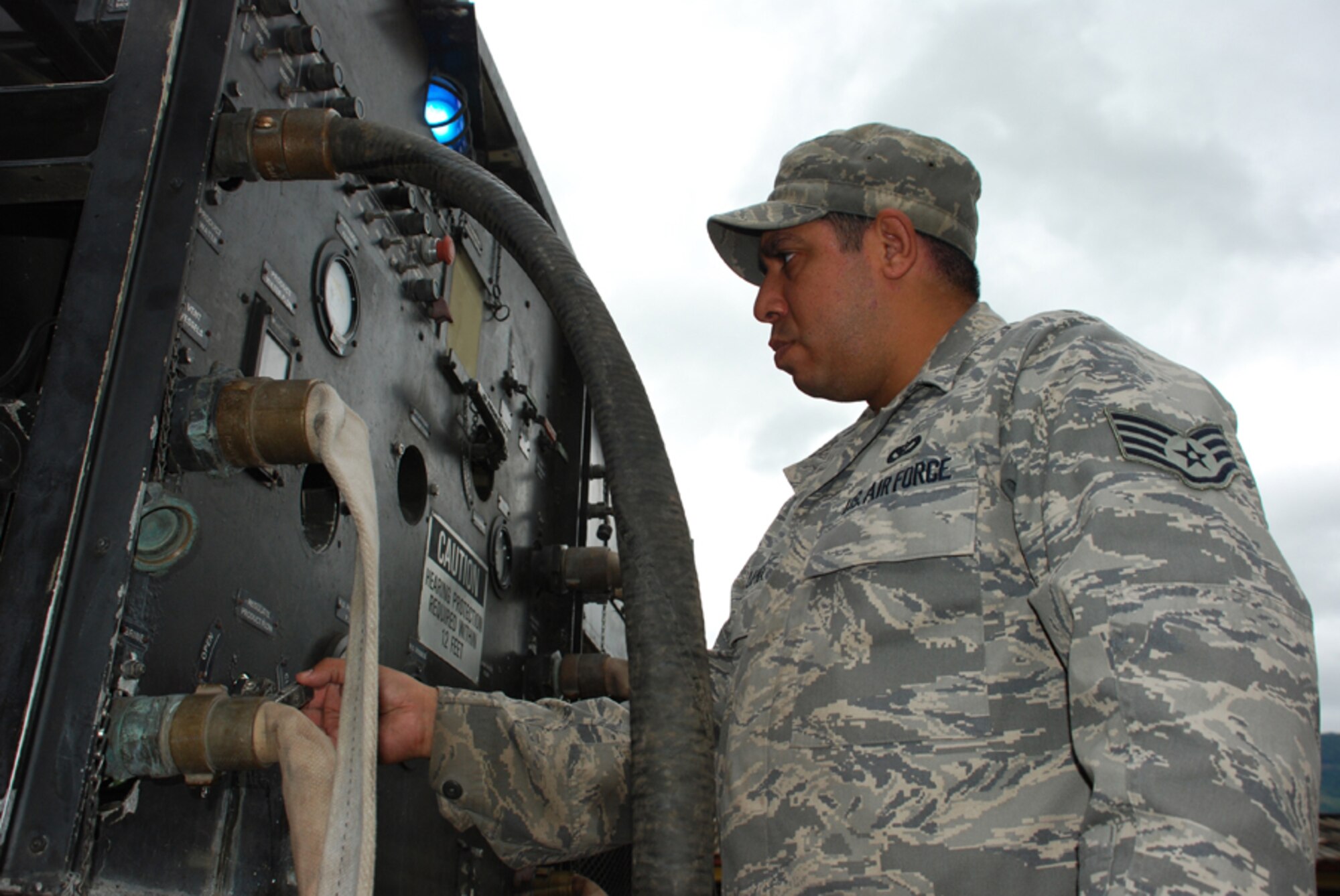 SOTO CANO AIR BASE, Honduras - Air Force Staff Sgt. Nick Luna, deployed from Dyess Air Force Base, Texas, works on a water filtration machine Oct. 29. Servicemembers from Joint Task Force-Bravo are participating in a 10-day operation in a nearby community to filter well water. The well water became undrinkable after more than a week long stretch of rain caused flooding in the area. (U.S. Army photo by Specialist Ethan Anderson)