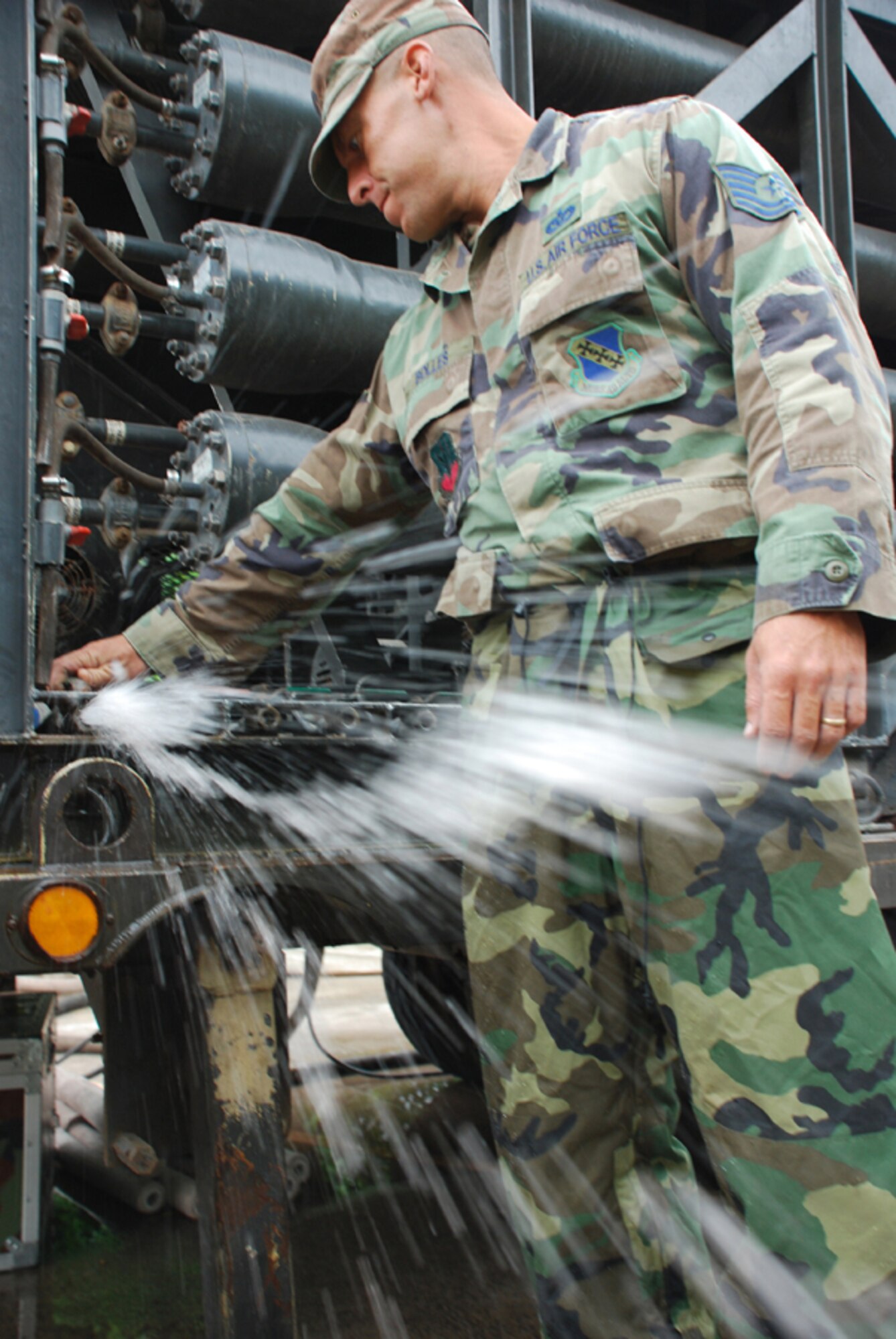 SOTO CANO AIR BASE, Honduras - Air Force Tech. Sgt. Shane Bolles, deployed from Dyess Air Force Base, Texas, works on a water filtration machine Oct. 29. Servicemembers from Joint Task Force-Bravo are participating in a 10-day operation in a nearby community to filter well water. The well water became undrinkable after more than a week long stretch of rain caused flooding in the area. (U.S. Air Force photo by Staff Sgt. Joel Mease) 