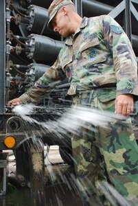 SOTO CANO AIR BASE, Honduras - Air Force Tech. Sgt. Shane Bolles, deployed from Dyess Air Force Base, Texas, works on a water filtration machine Oct. 29. Servicemembers from Joint Task Force-Bravo are participating in a 10-day operation in a nearby community to filter well water. The well water became undrinkable after more than a week long stretch of rain caused flooding in the area. (U.S. Air Force photo by Staff Sgt. Joel Mease) 