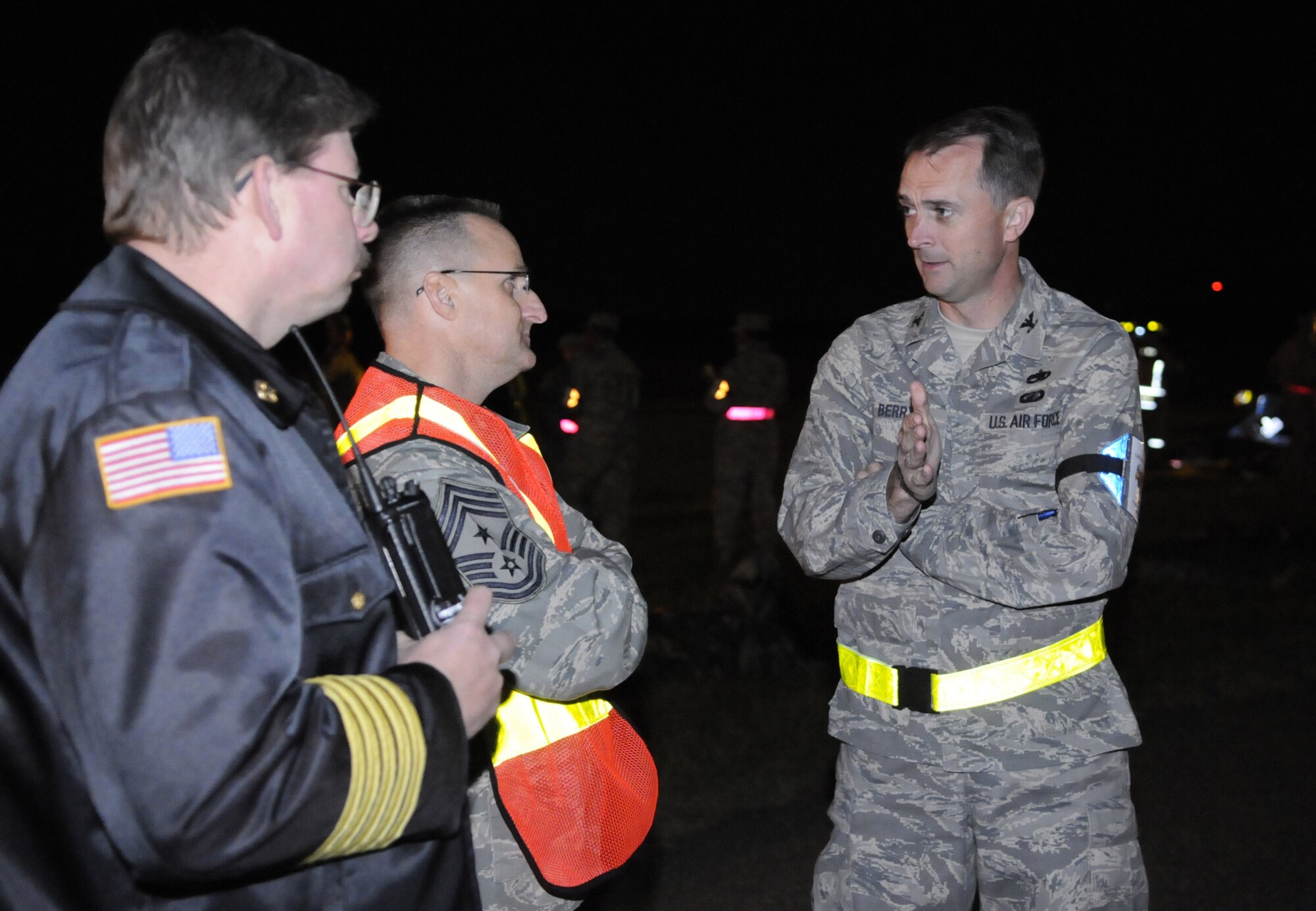 L-R,Donald Striejewske, 778th CES fire chief, CMSgt. Harold L. Hutchison, 78th Air Base Wing command chief, and Col. Warren Berry, 78th ABW commander discuss the exercise while it is in progress Oct. 22. U. S. Air Force photo by Sue Sapp